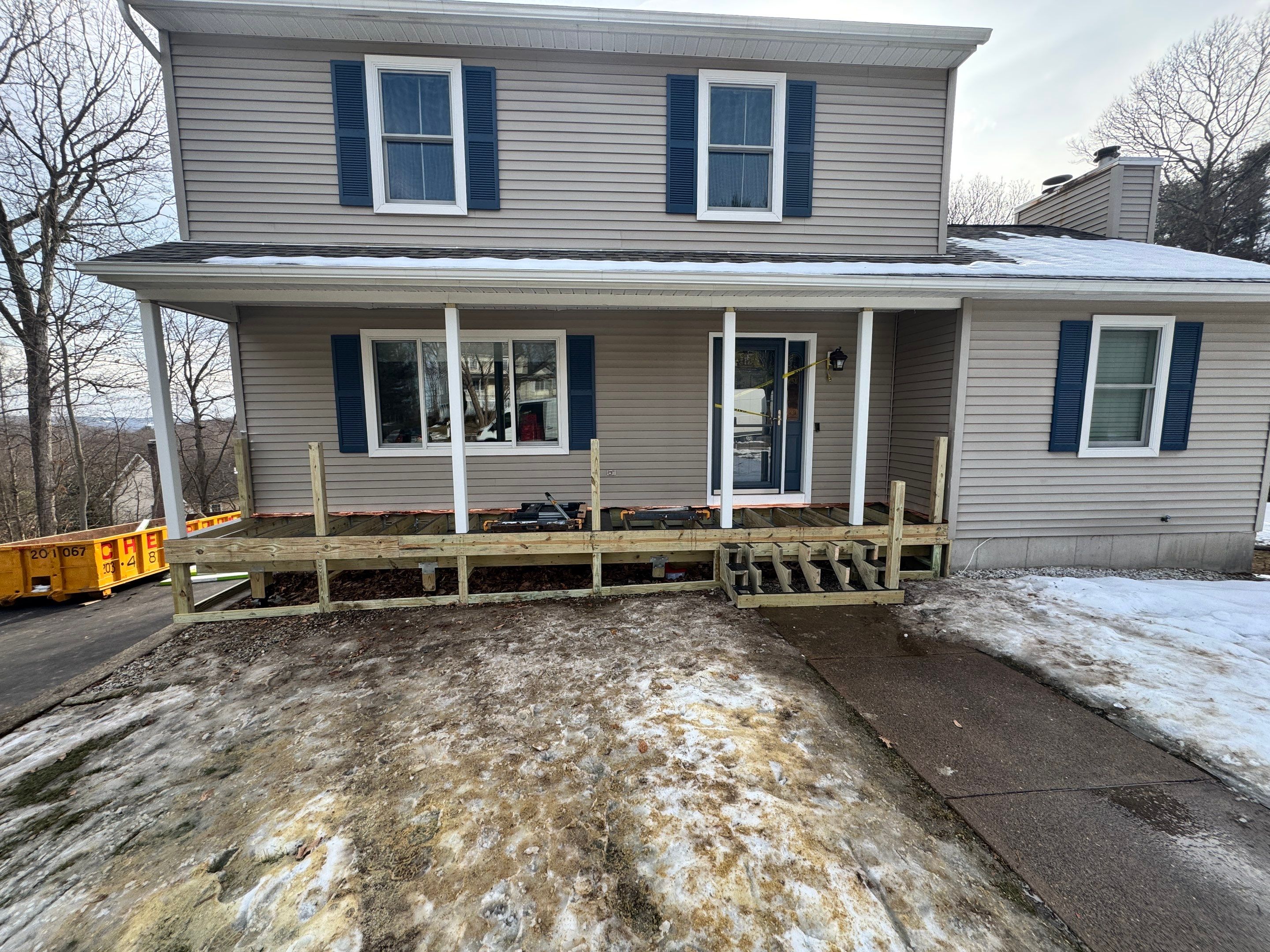 Replacement front porch using Trex Tropical Island mist and White composite railings. Includes lattice bottom. by DiGiorgi Roofing and Siding Inc