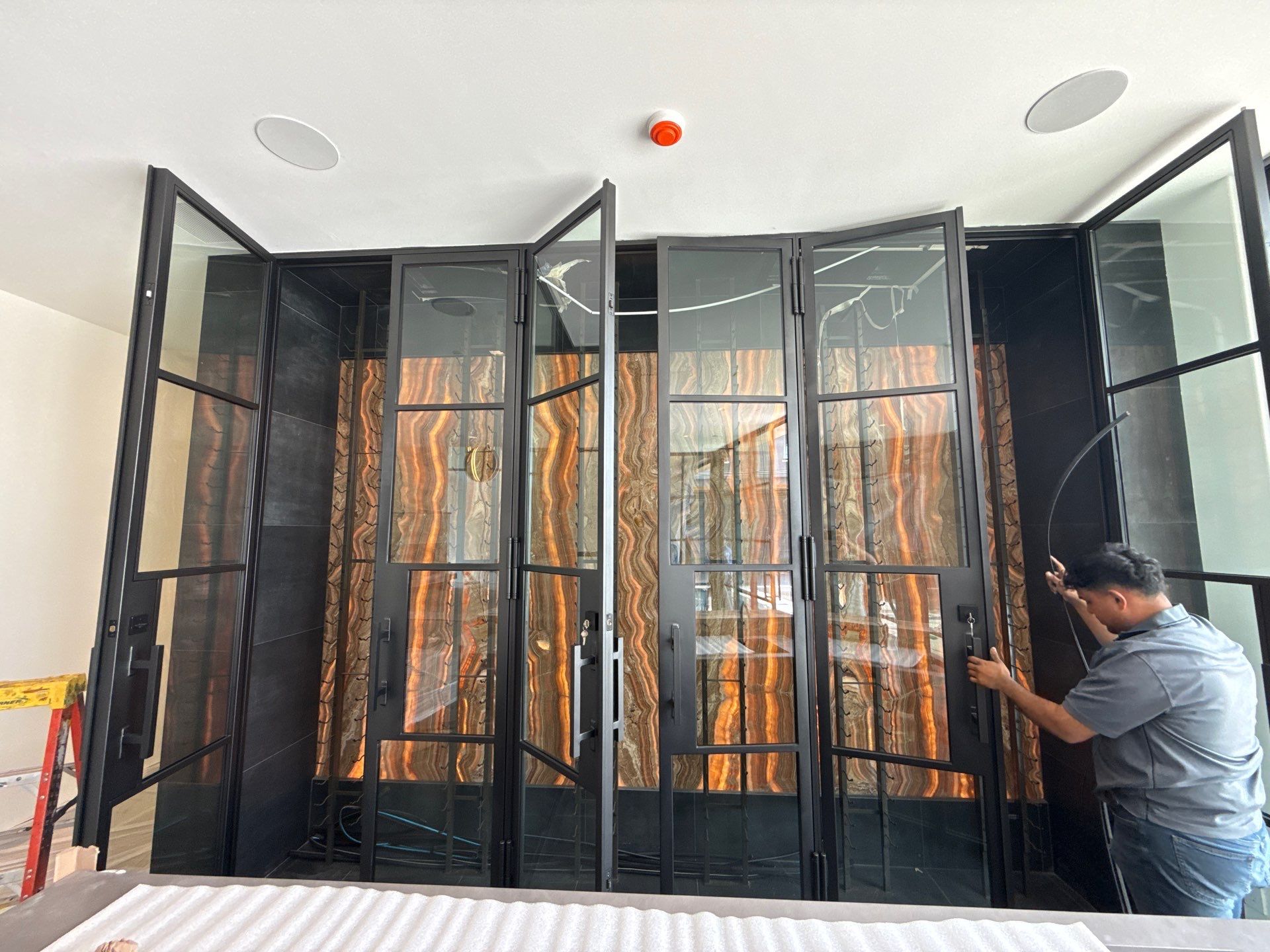 Custom Black-Framed Glass Wine Cellar Installation in Dallas by Solara Custom Living