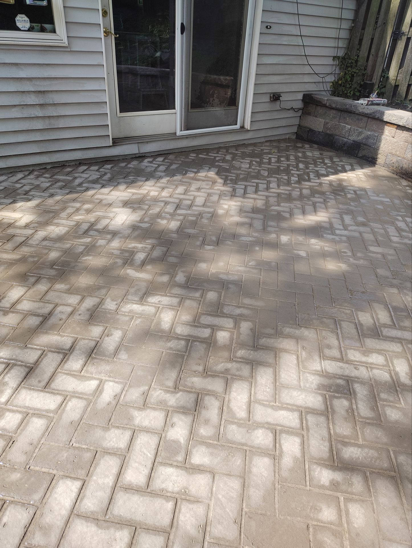 Stamped Concrete and Retaining Wall by Cousins Roofing Siding & Decks