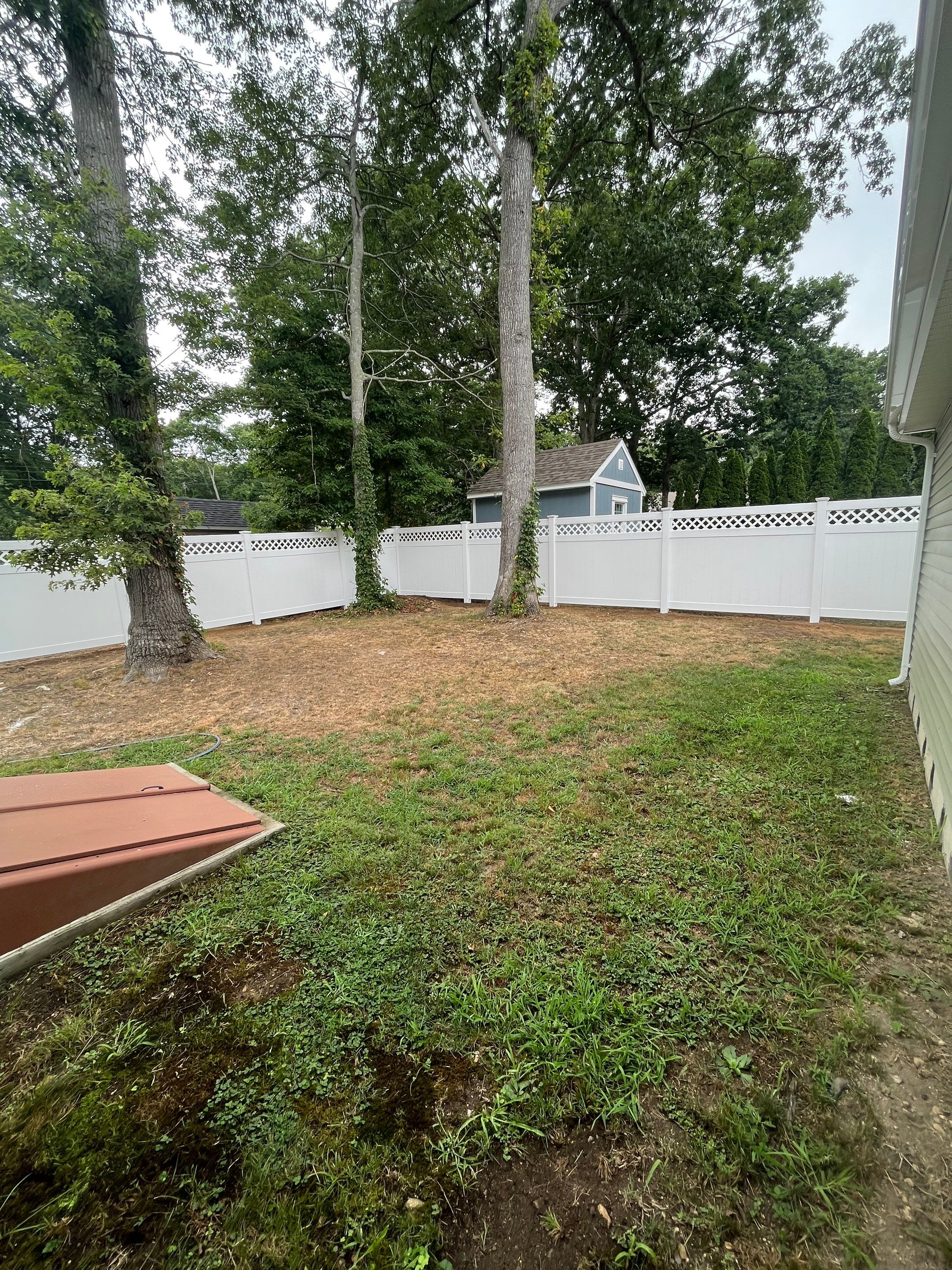 Vinyl privacy fence with Lattice top, White  by DiGiorgi Roofing and Siding Inc