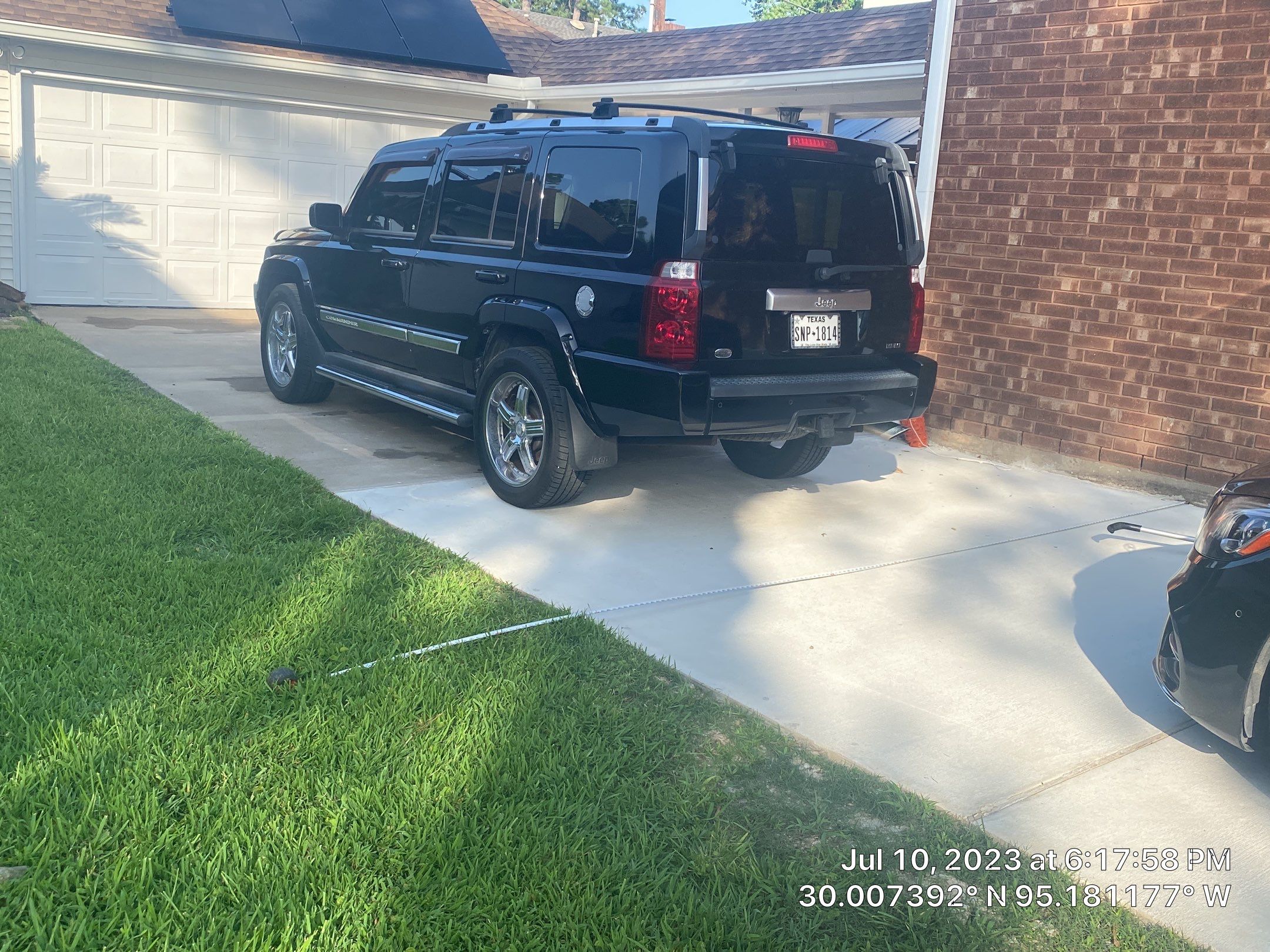 Complete metal driveway gate install with solar powered opener. Metal fence frame with Cedar Pickets by Astro Outdoor Designs 
