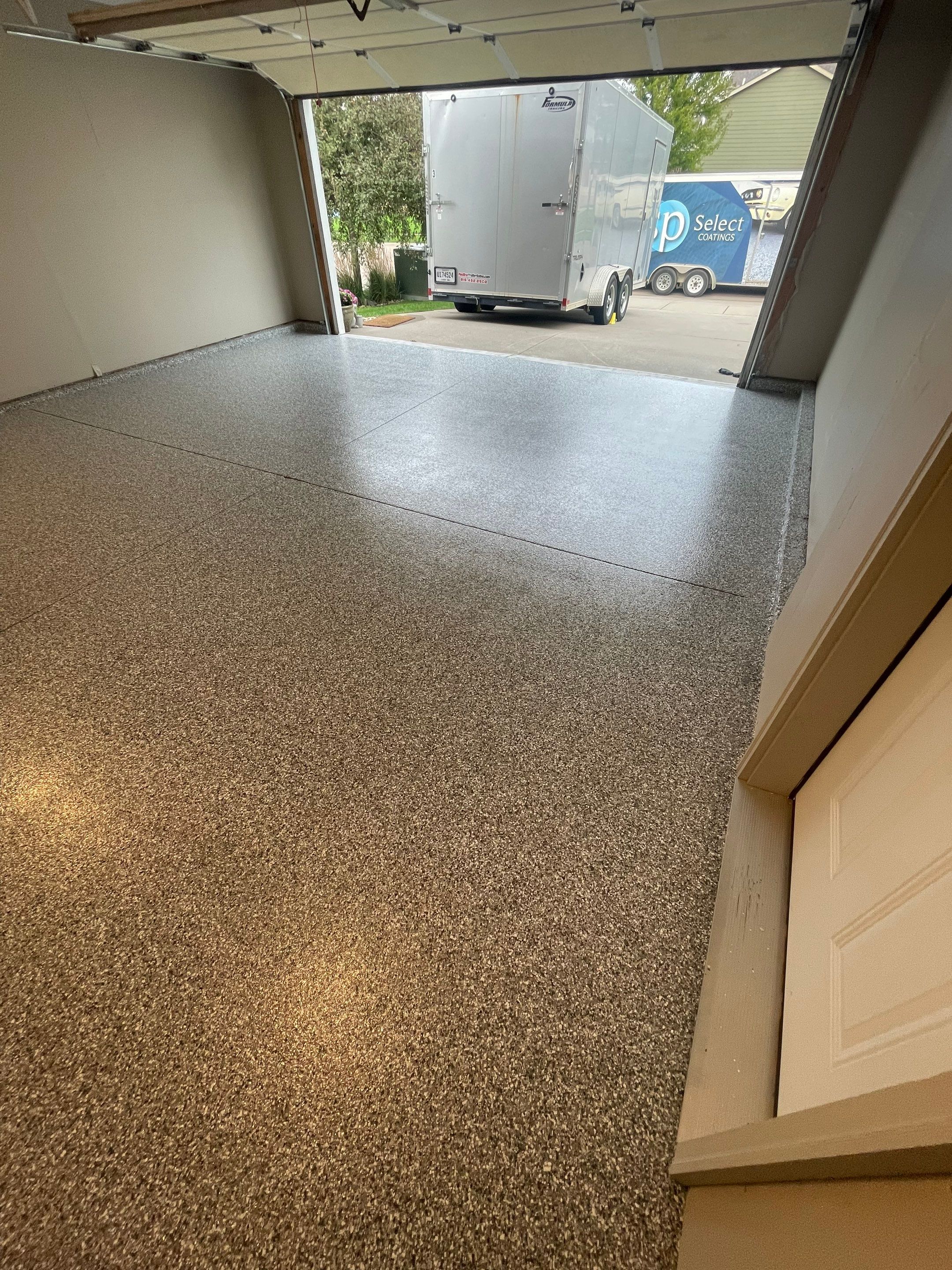 Custom Polyurea Flake Garage Floor Installation in Sioux Falls by Select Painting, Coatings & Garage Cabinets