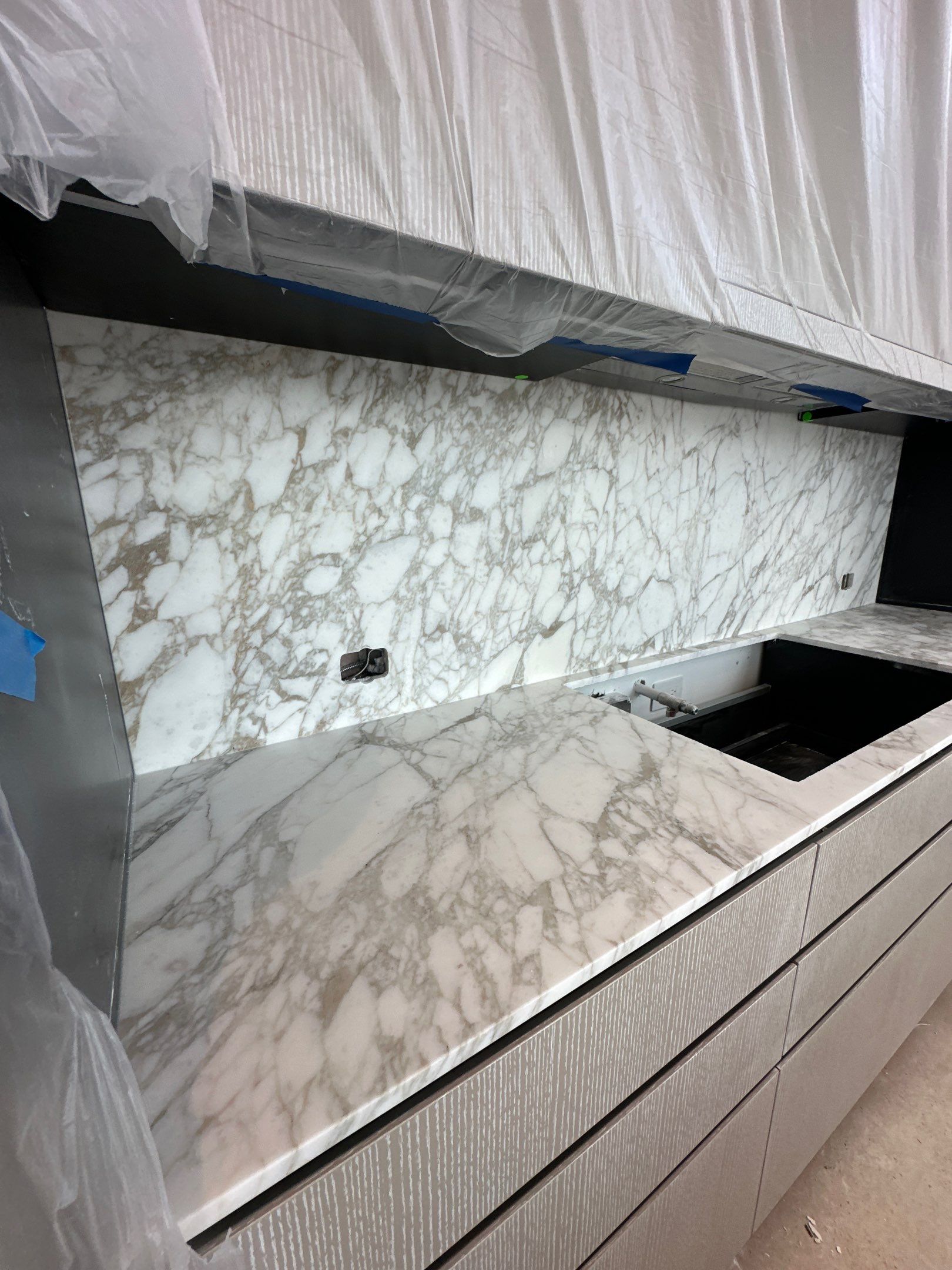 Kitchen Countertop with backsplash and Island top with mitered waterfalls by NC Stone And Tiles
