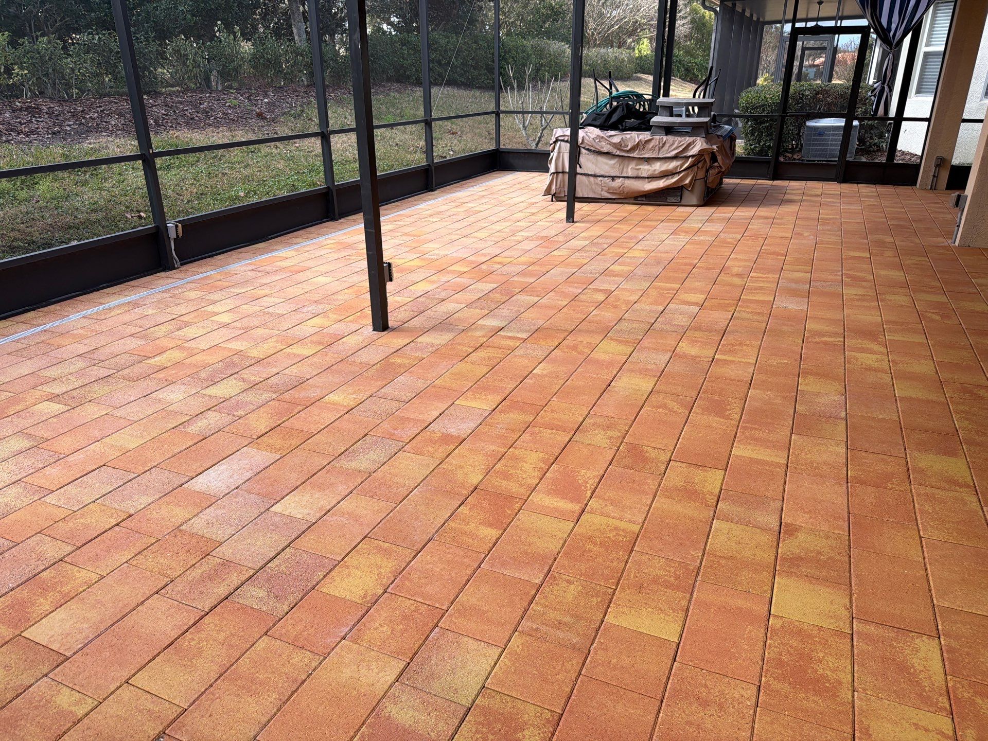 Paver Sealing for Herringbone Driveway and Screened Lanai in Valencia Lakes by Supreme Paver Experts