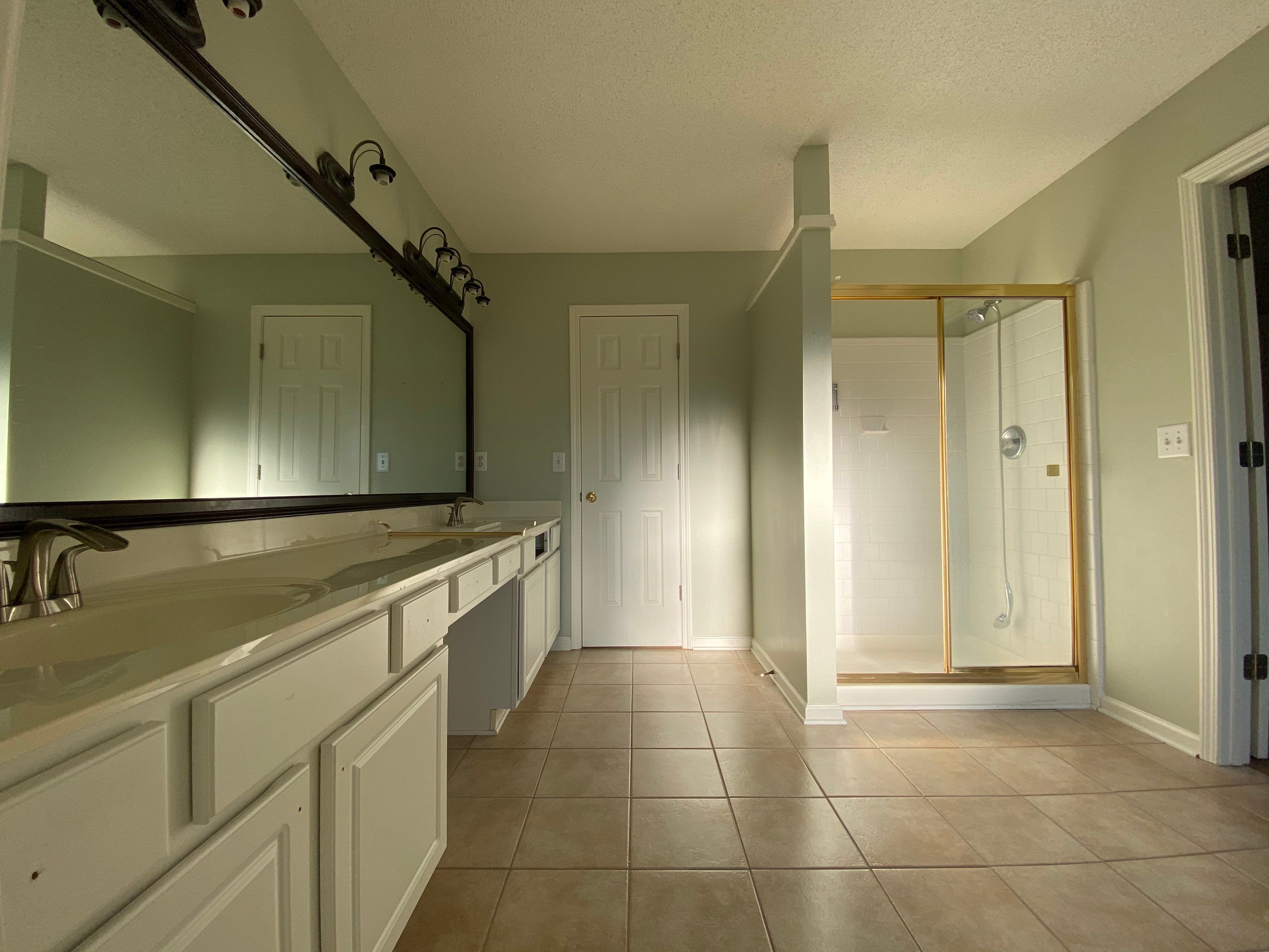 Master Bathroom Renovation Featuring Marble-Look Tile and Frameless Glass by Swift Home Renovations