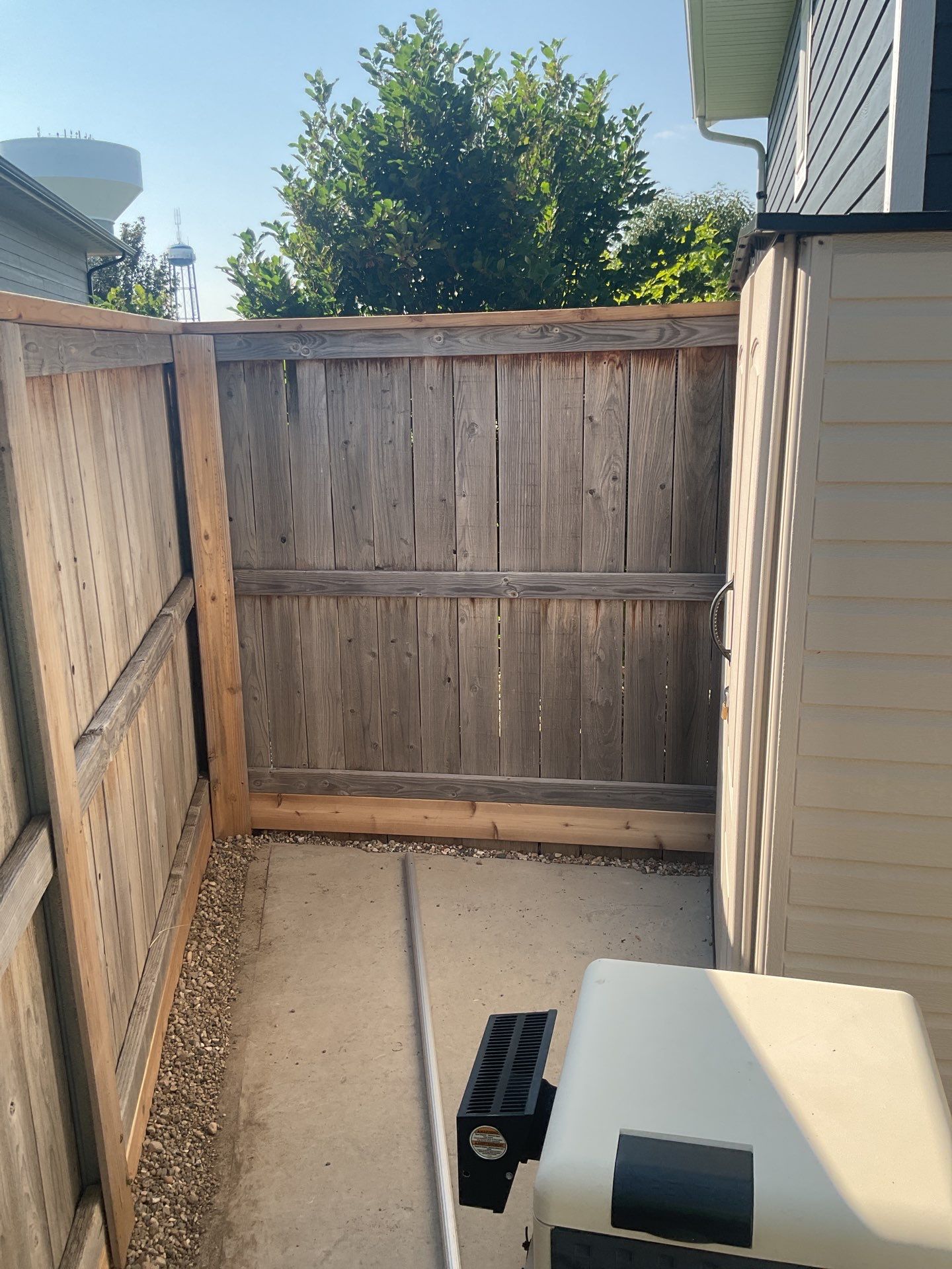 Custom Privacy Fence and Paver Patio Installation in Sioux Falls by Select Painting, Coatings & Garage Cabinets