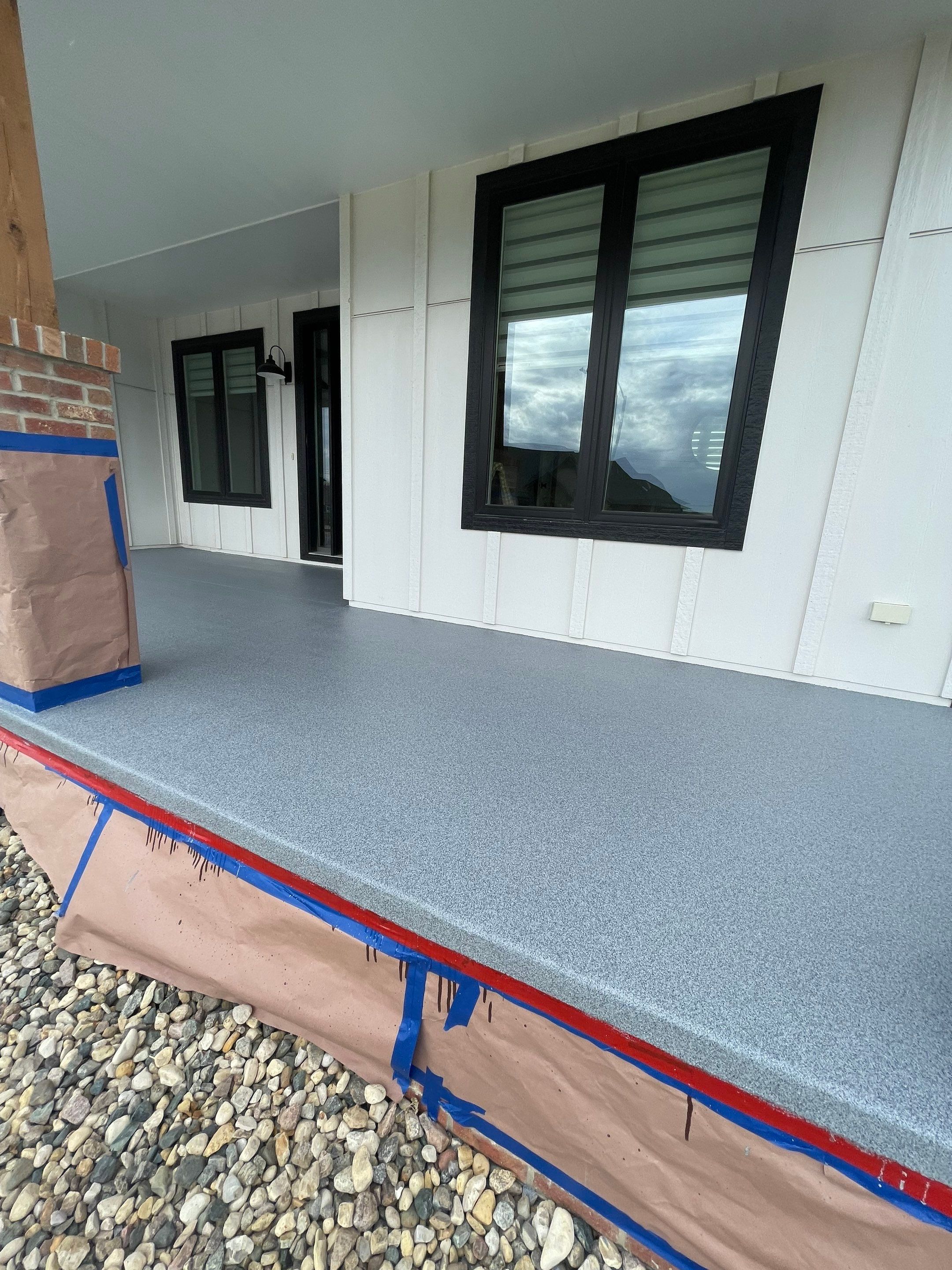 Grey Speckled Concrete Porch Coating for Sioux Falls Home by Select Painting, Coatings & Garage Cabinets