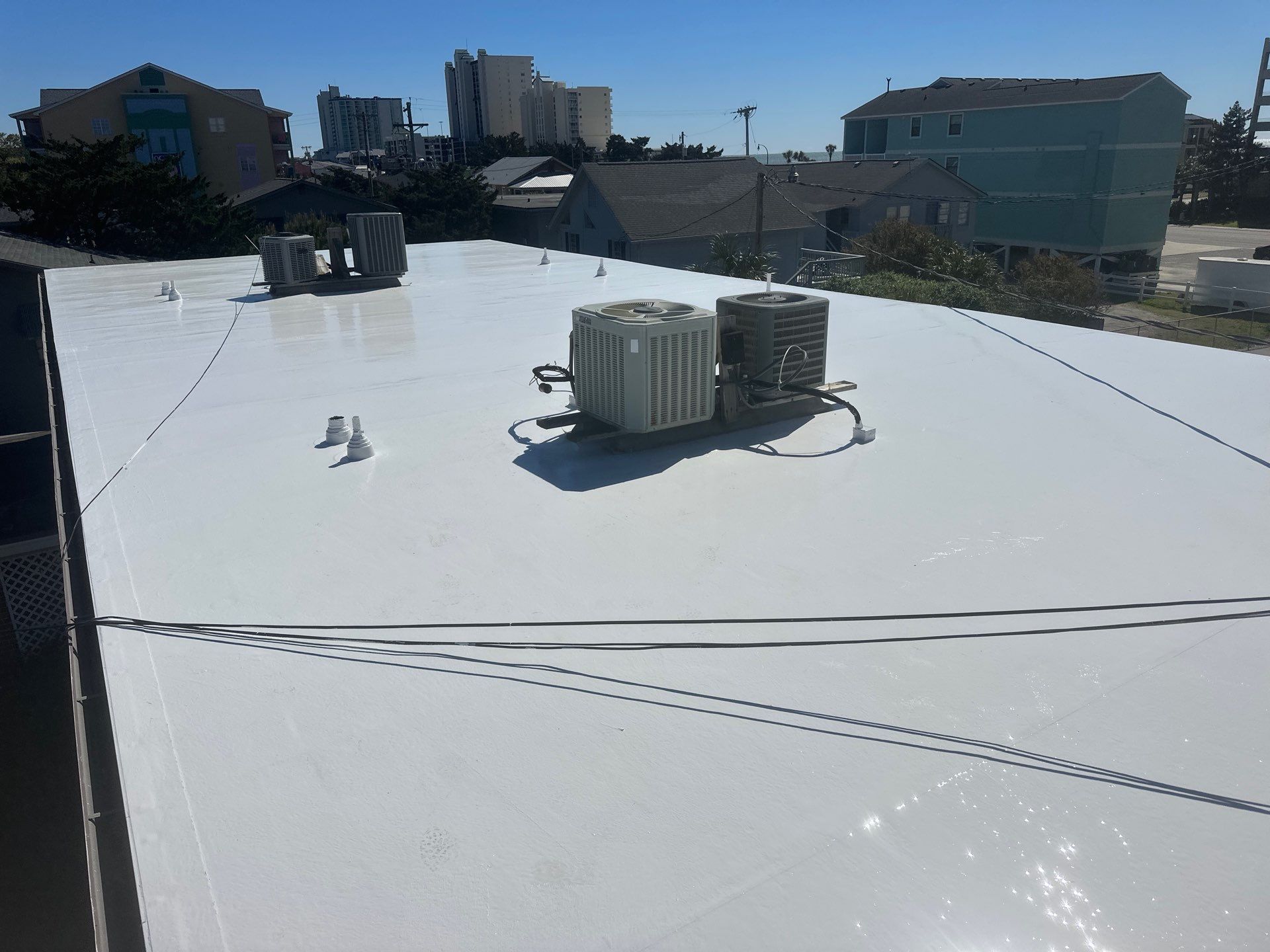 Commercial Building Roof Coating using 924 Eterna-Sil Premium Silicone Roof Coating by RGR Construction and Roofing, LLC