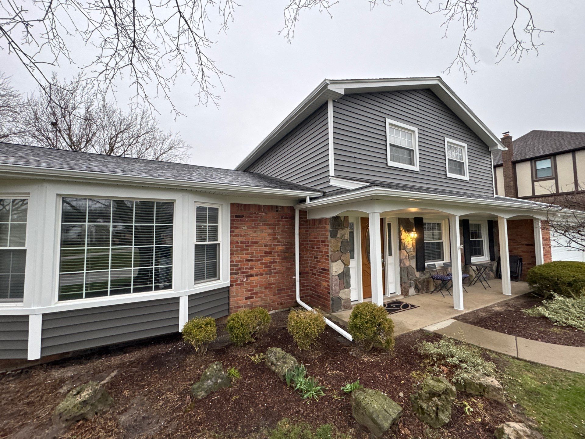 Siding Replacement using Alside Charcoal Smoke and Roof Replacement using Owens Corning Peppercorn by 180 Contractors