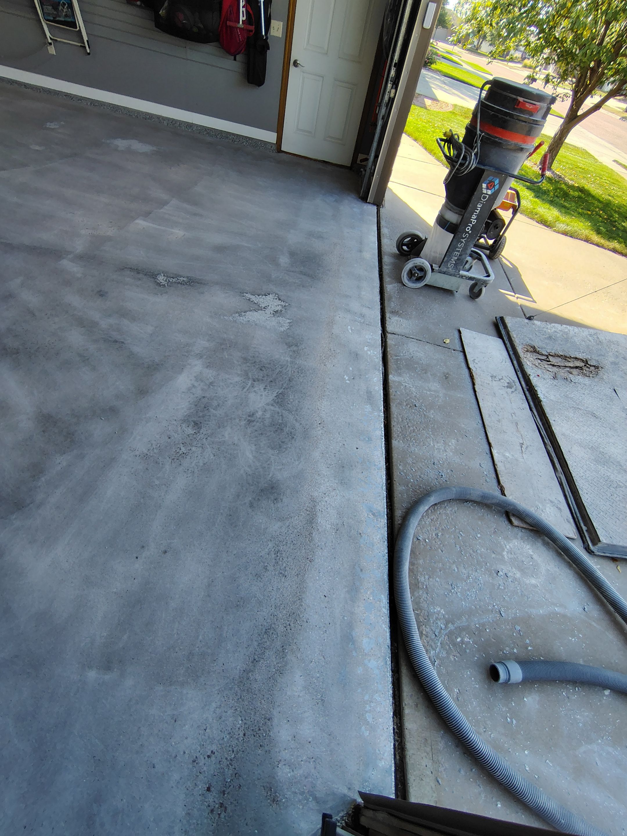 Grey Flecked Epoxy Garage Floor Installation in Sioux Falls by Select Painting, Coatings & Garage Cabinets