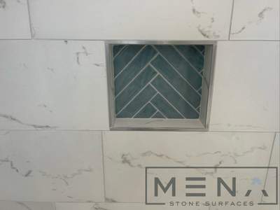 Complete Bathroom Remodel Featuring Marble Tile and Teal Herringbone Niche