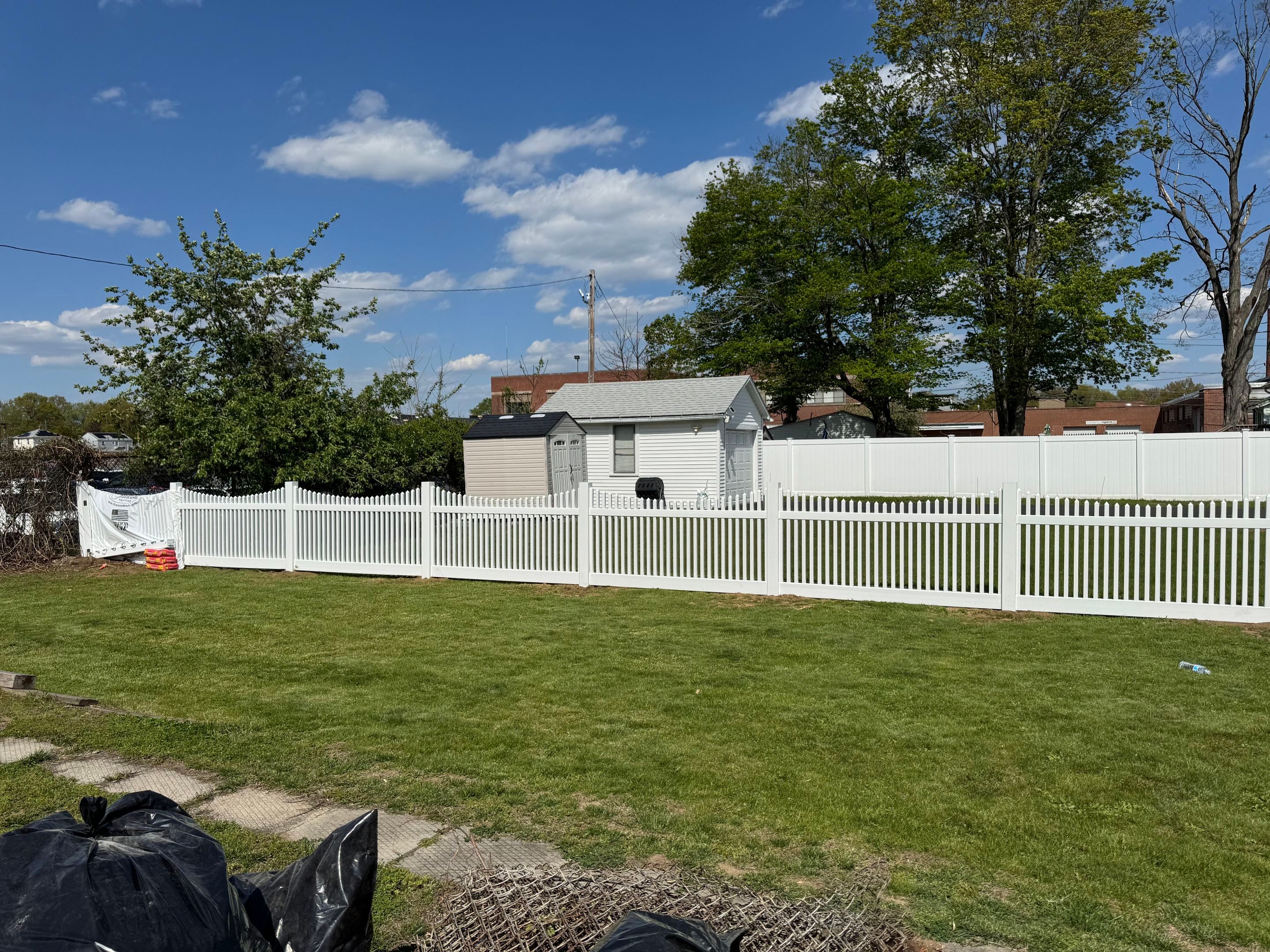 Fence replacement using White Vinyl picket with scalloped edge. by DiGiorgi Roofing and Siding Inc