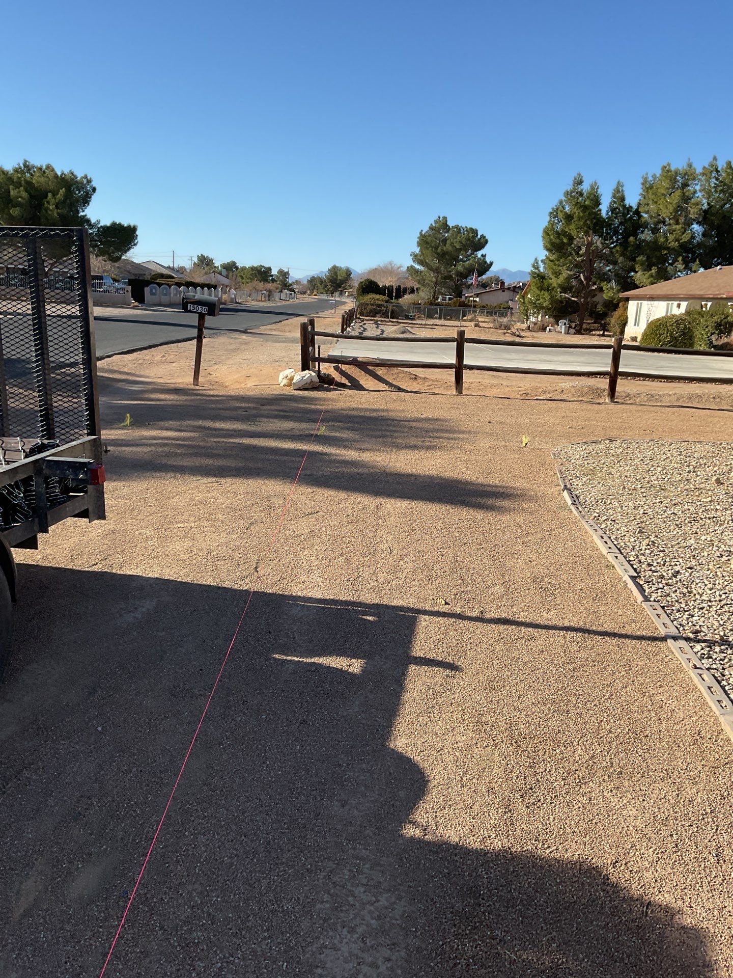 Sleek chain link fence installation with a solar motorized gate by Fence Guys Inc.