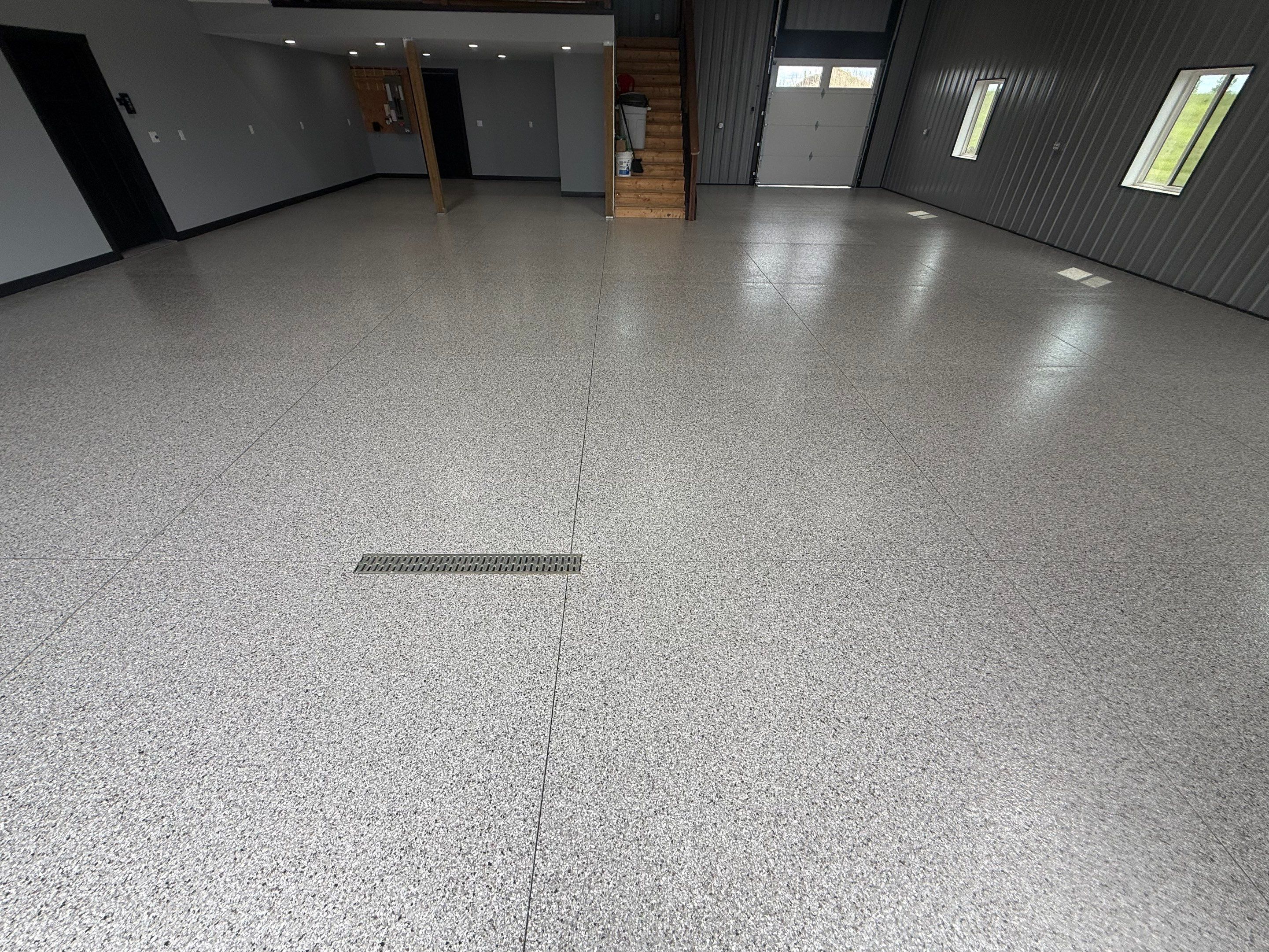 Polyaspartic Garage Floor Coating with Decorative Flake in Wentworth by Select Painting, Coatings & Garage Cabinets