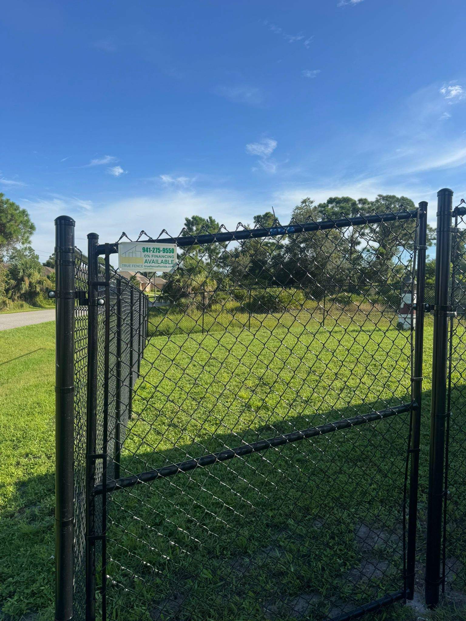 Black Vinyl-Coated Chain Link Fence and Gate Installation in North Port by True Fence LLC