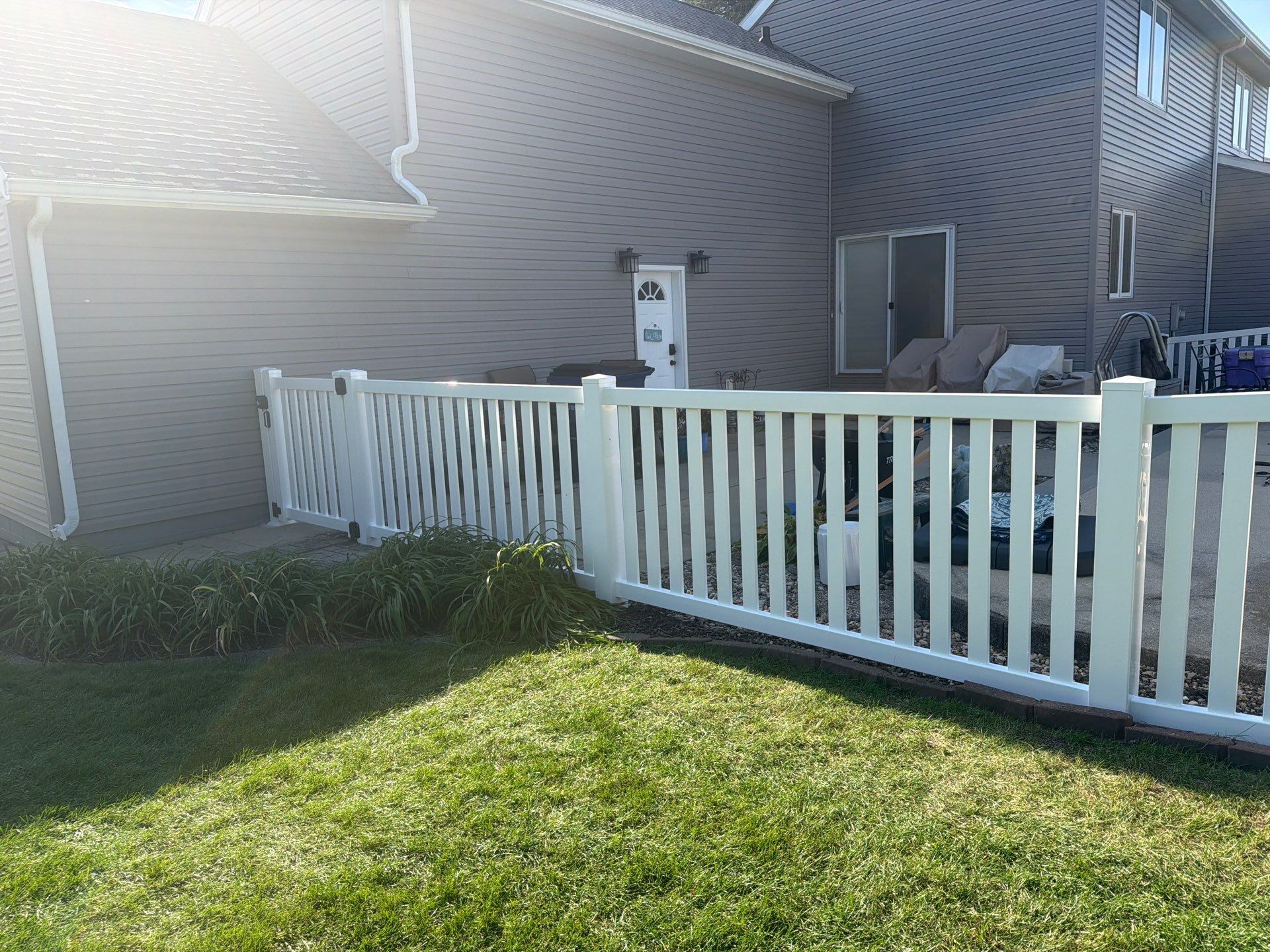 White Vinyl Picket Pool Fence Installation in Waterloo, Iowa by Perfect Picket Fence and Stain