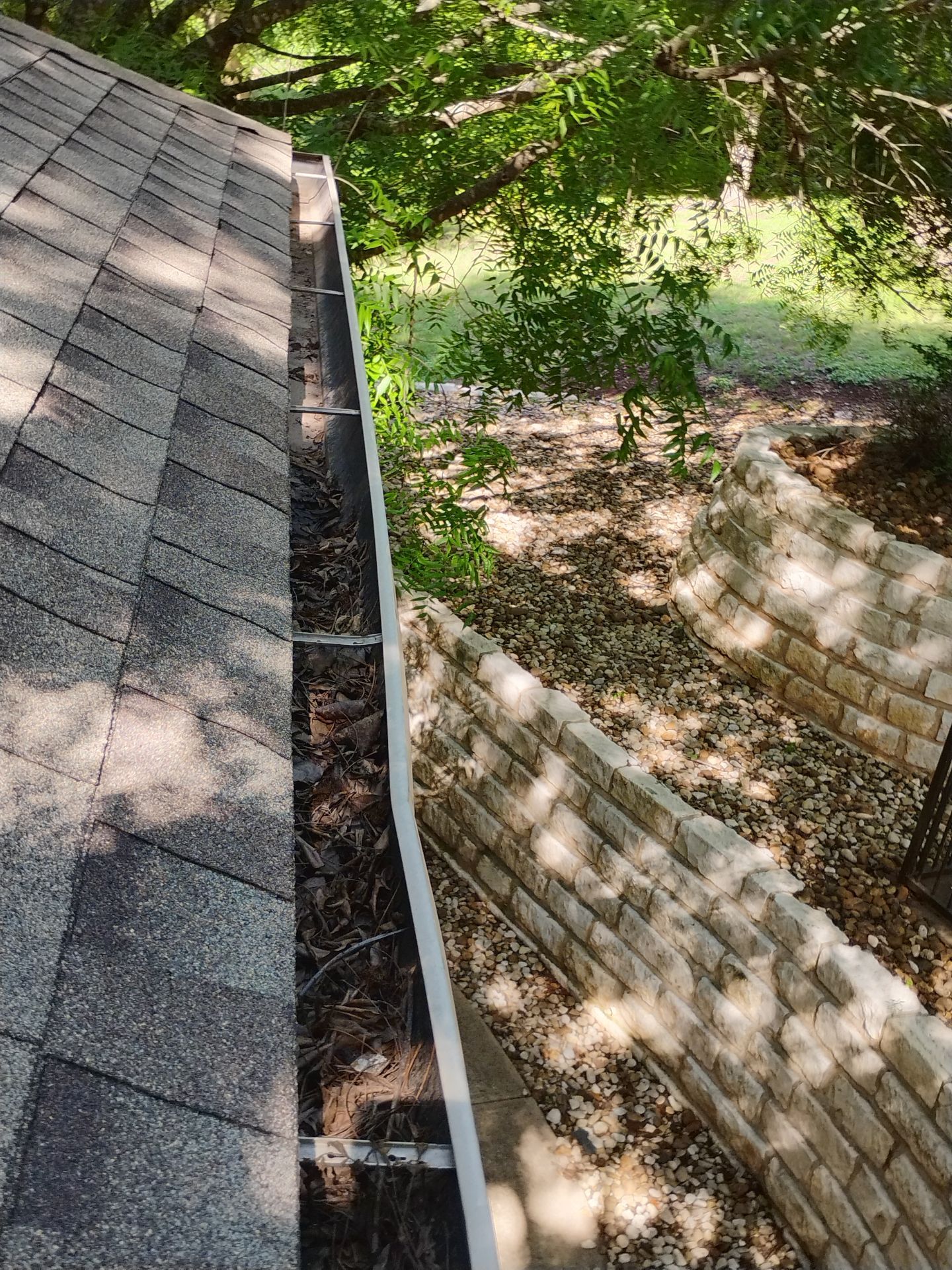 Commercial gutter cleaning Round Rock & Georgetown, TX	 before photo with filled gutters
