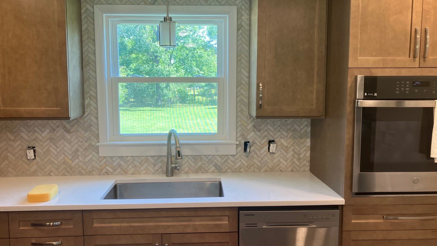 Beautiful Herringbone Backsplash  by Footprints Floors of Nashville