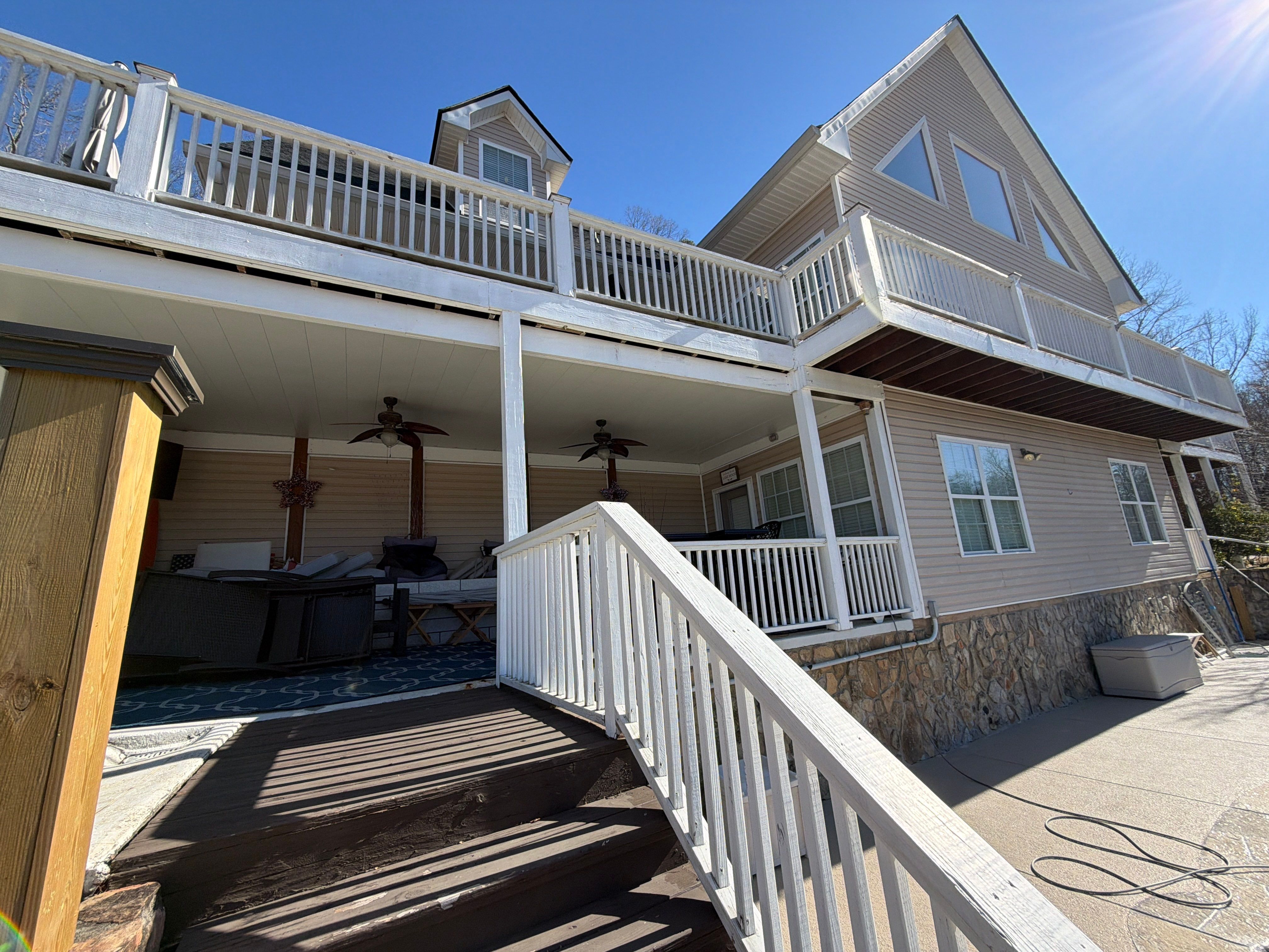 Cumming, GA Lake House Deck Resurface and Extension using Pressure Treated Pine and Skyline Cable Railing by Nelson Exteriors 