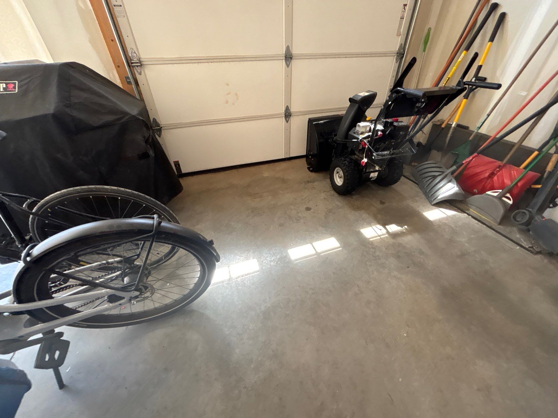 Grey Flake Epoxy Garage Floor Coating in Sioux Falls by Select Painting, Coatings & Garage Cabinets