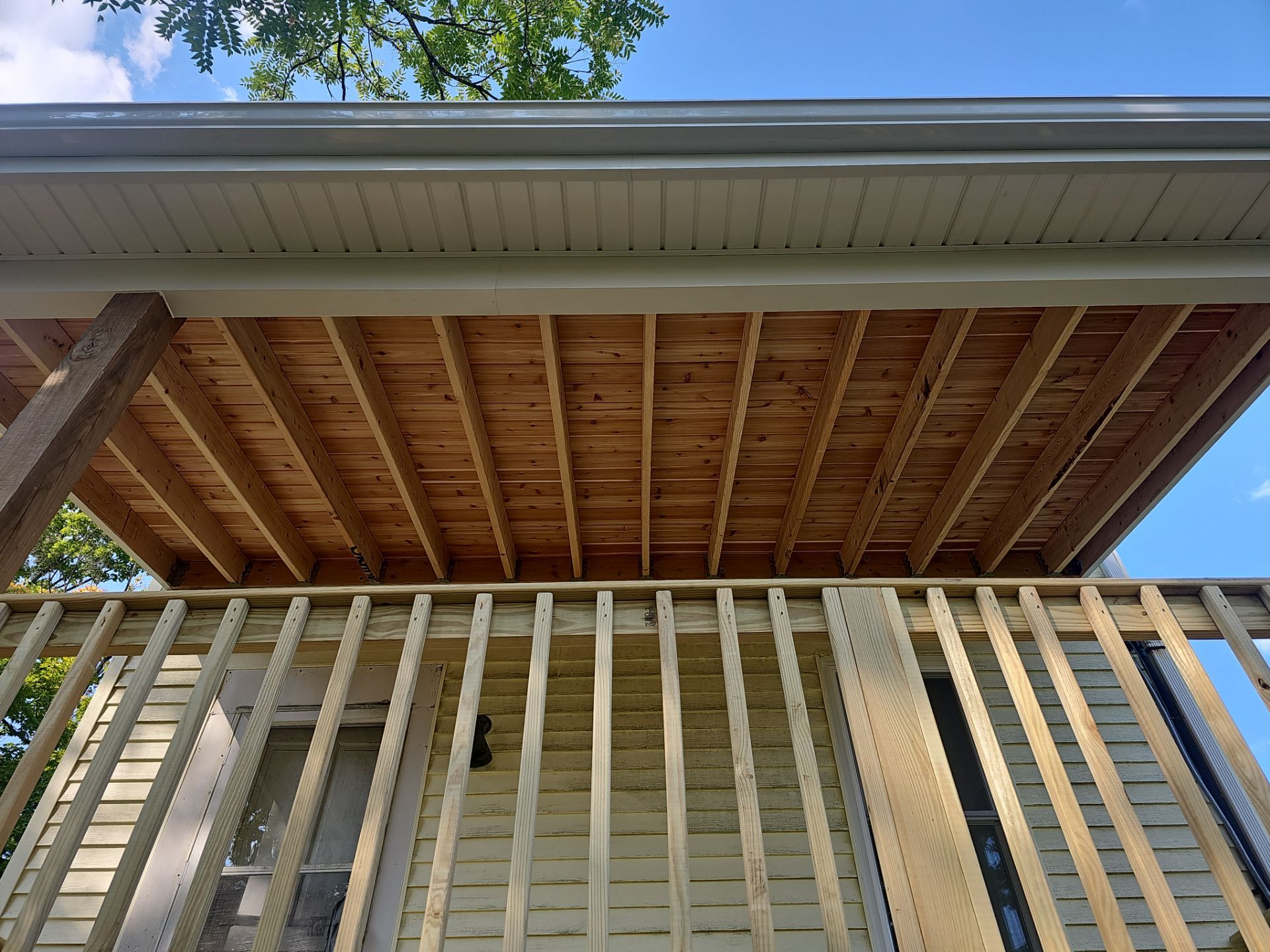 Deck and shed roof by Cousins Roofing Siding & Decks
