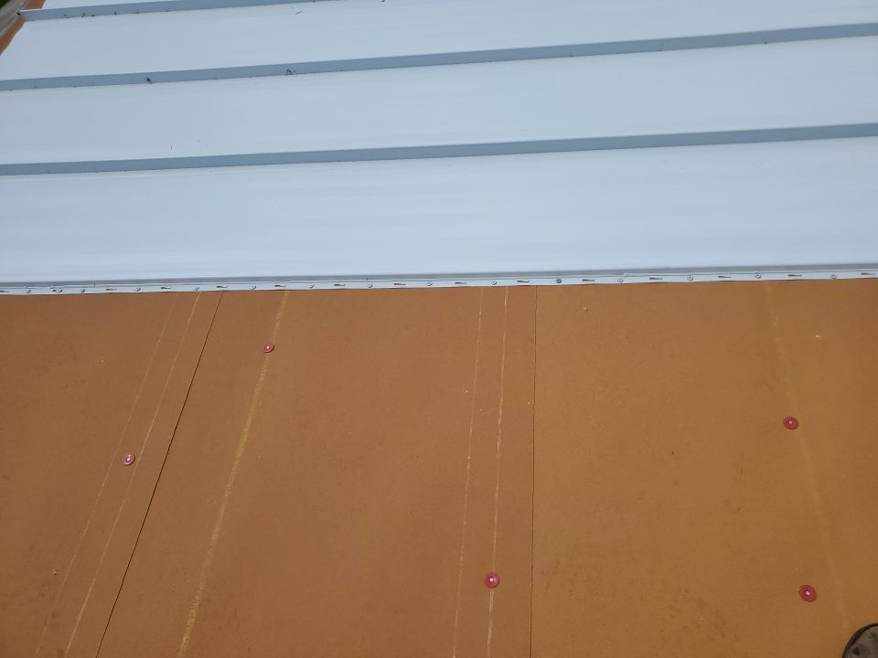 Residential Roofing Installation using 1.5" Nail Strip 24ga Solar White Kynar Coated Standing Seam Metal Panels by Morton Roofing, Inc.