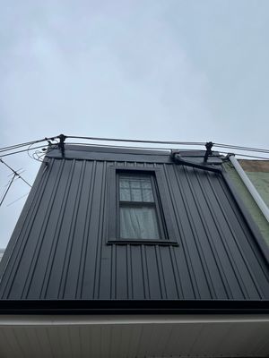 Vertical Black Metal Siding Installation for Philadelphia Home Exterior