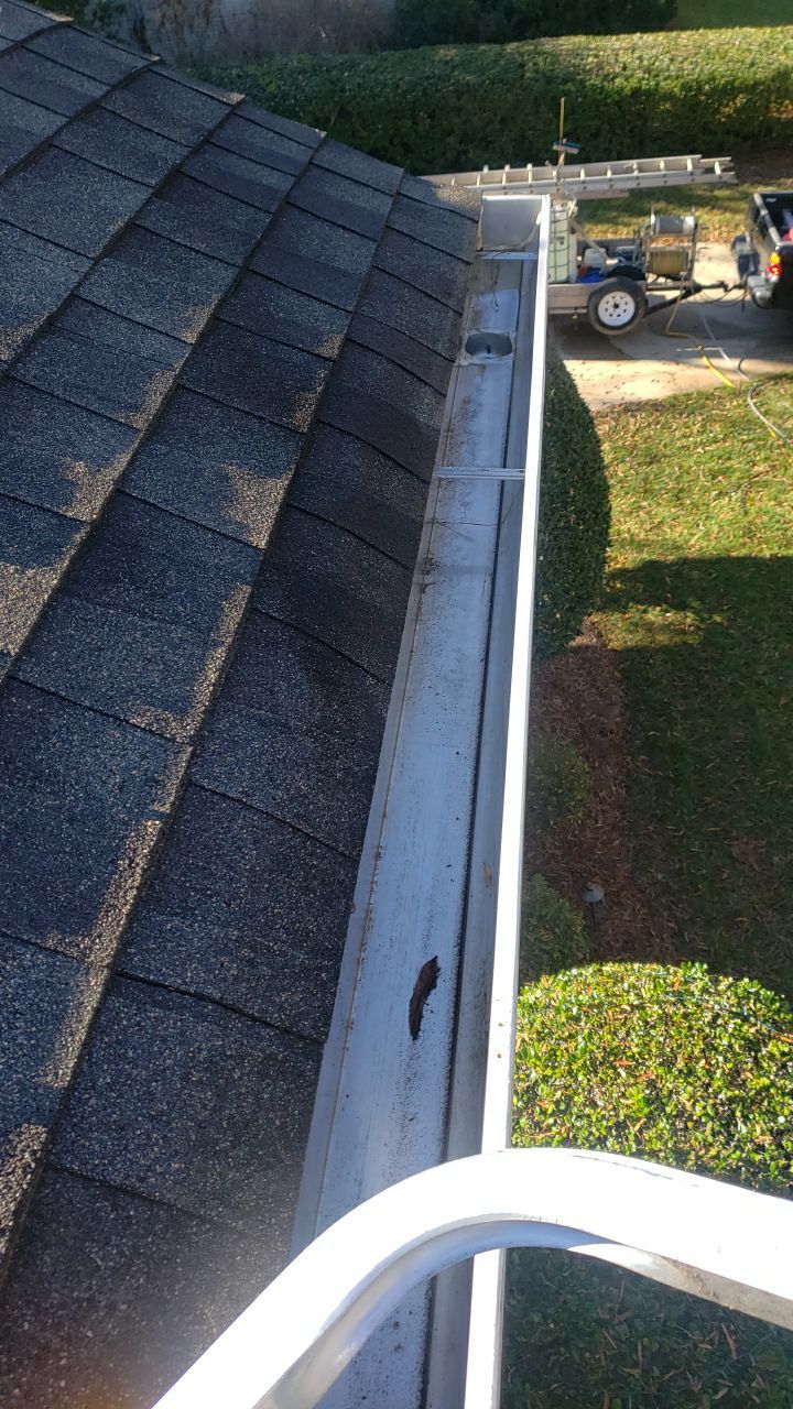 Sara Gutter cleanout using water by Power Wash Masters LLC