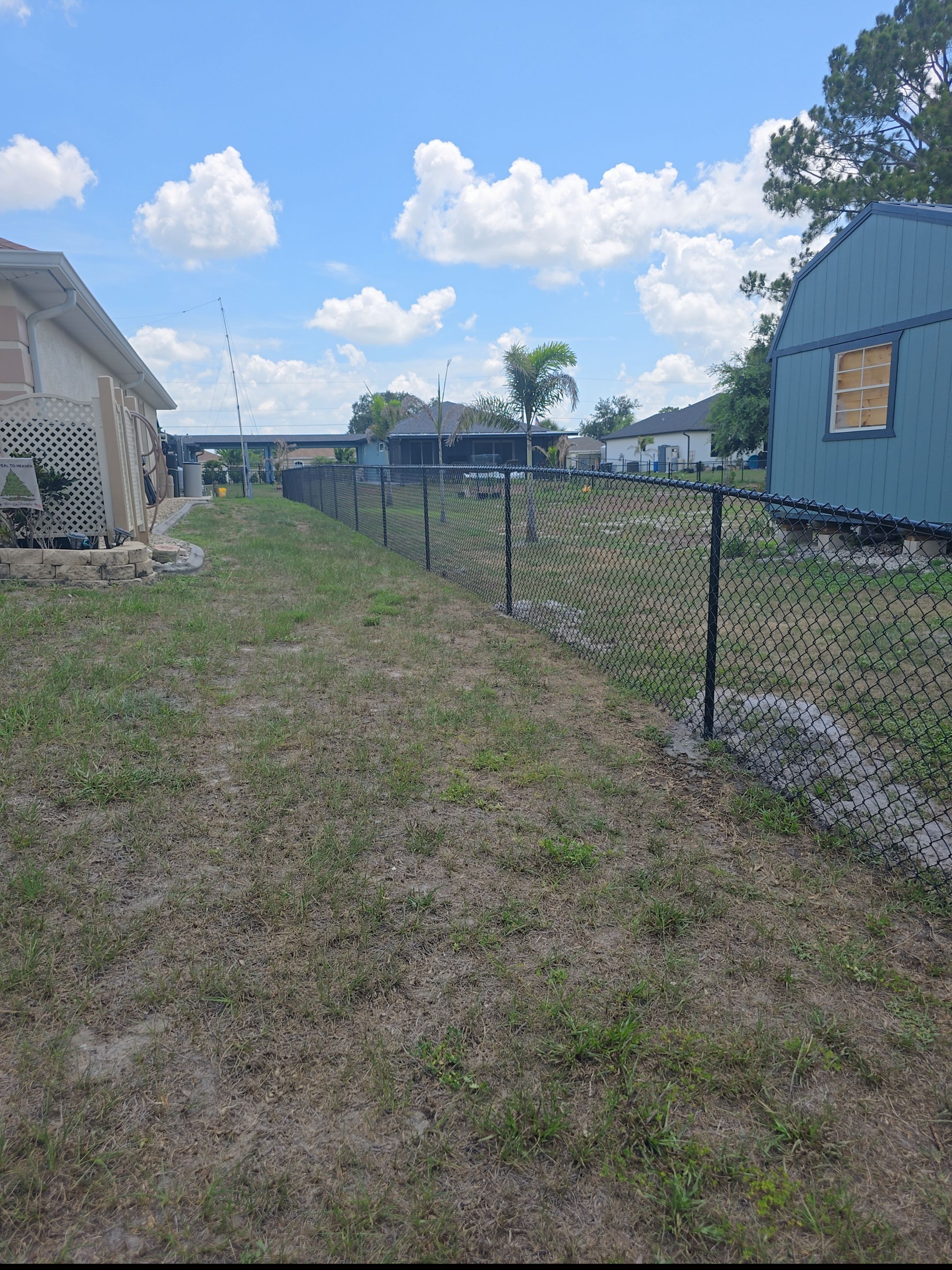Black Vinyl-Coated Chain Link Fence and Rolling Gate Installation in North Port by True Fence LLC