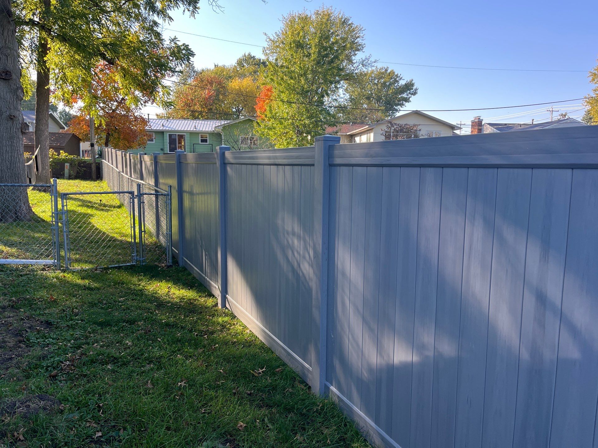 Chai Gray Vinyl Privacy Fence and Gate Installation in Cedar Falls by Perfect Picket Fence and Stain