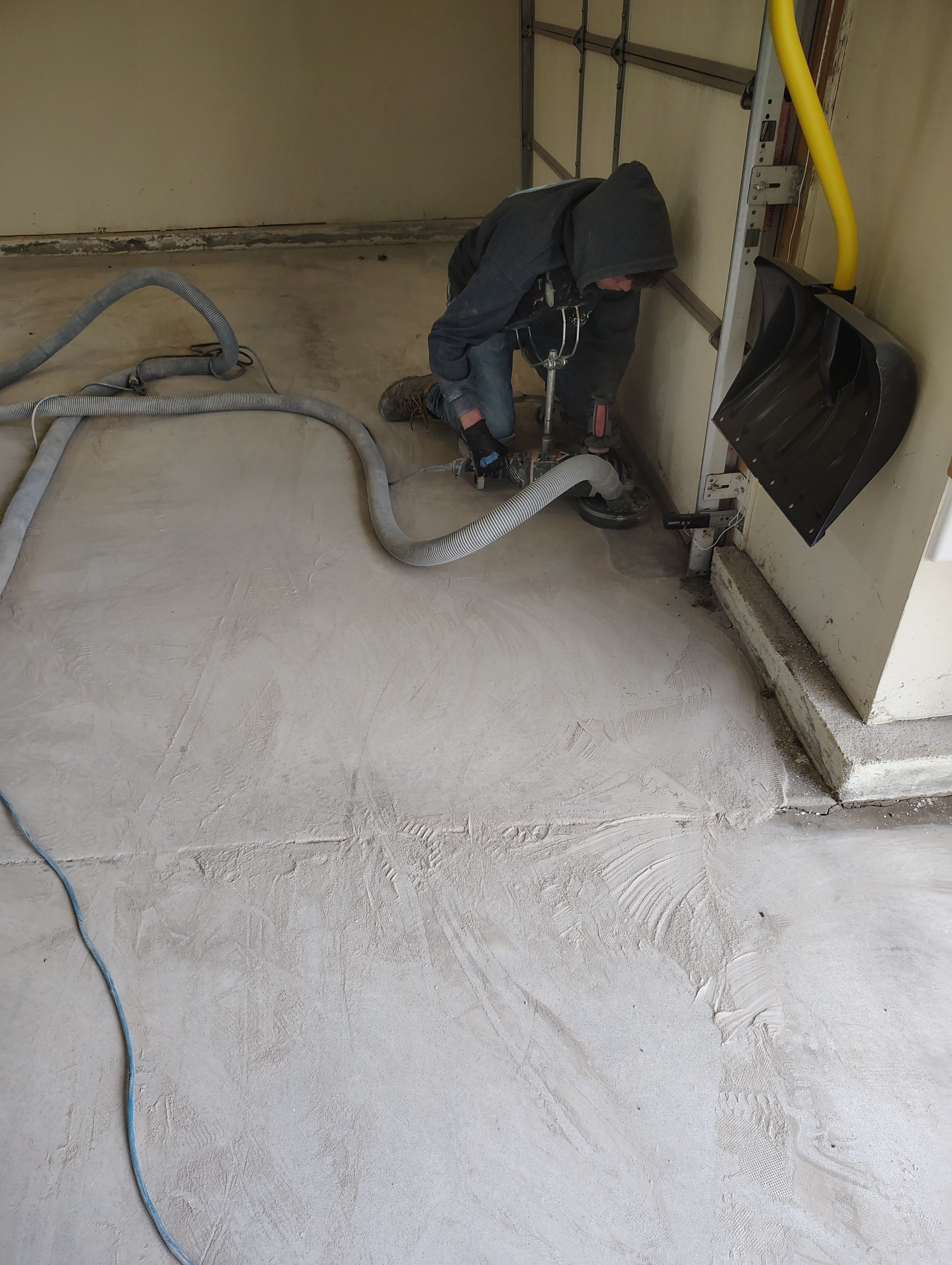 Sioux Falls Garage Floor Repair and Speckled Epoxy Coating Installation by Select Painting, Coatings & Garage Cabinets