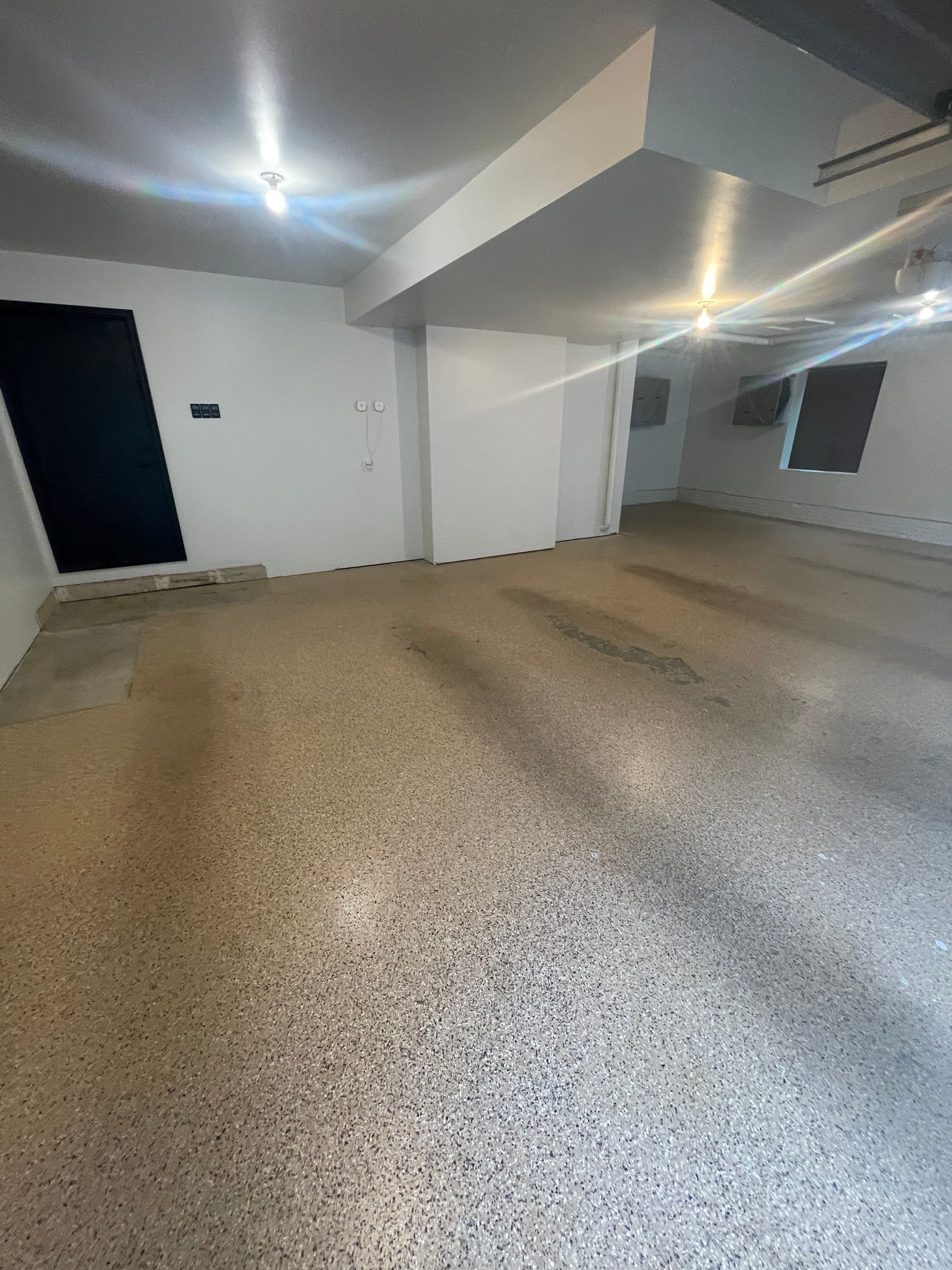 Gray Speckled Epoxy Garage Floor Coating in Sioux Falls by Select Painting, Coatings & Garage Cabinets
