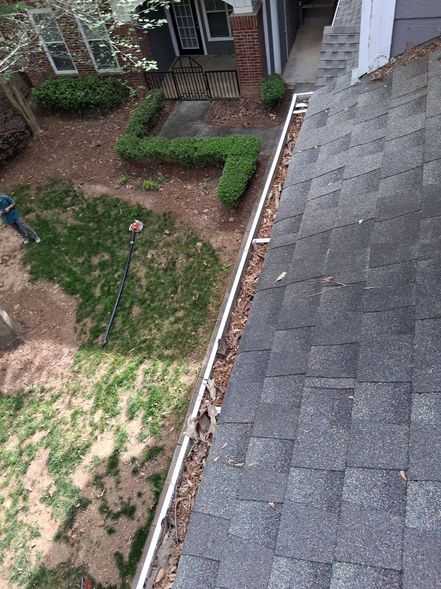 HOA gutter cleaning in Huntersville, NC,before photo showing full gutters.