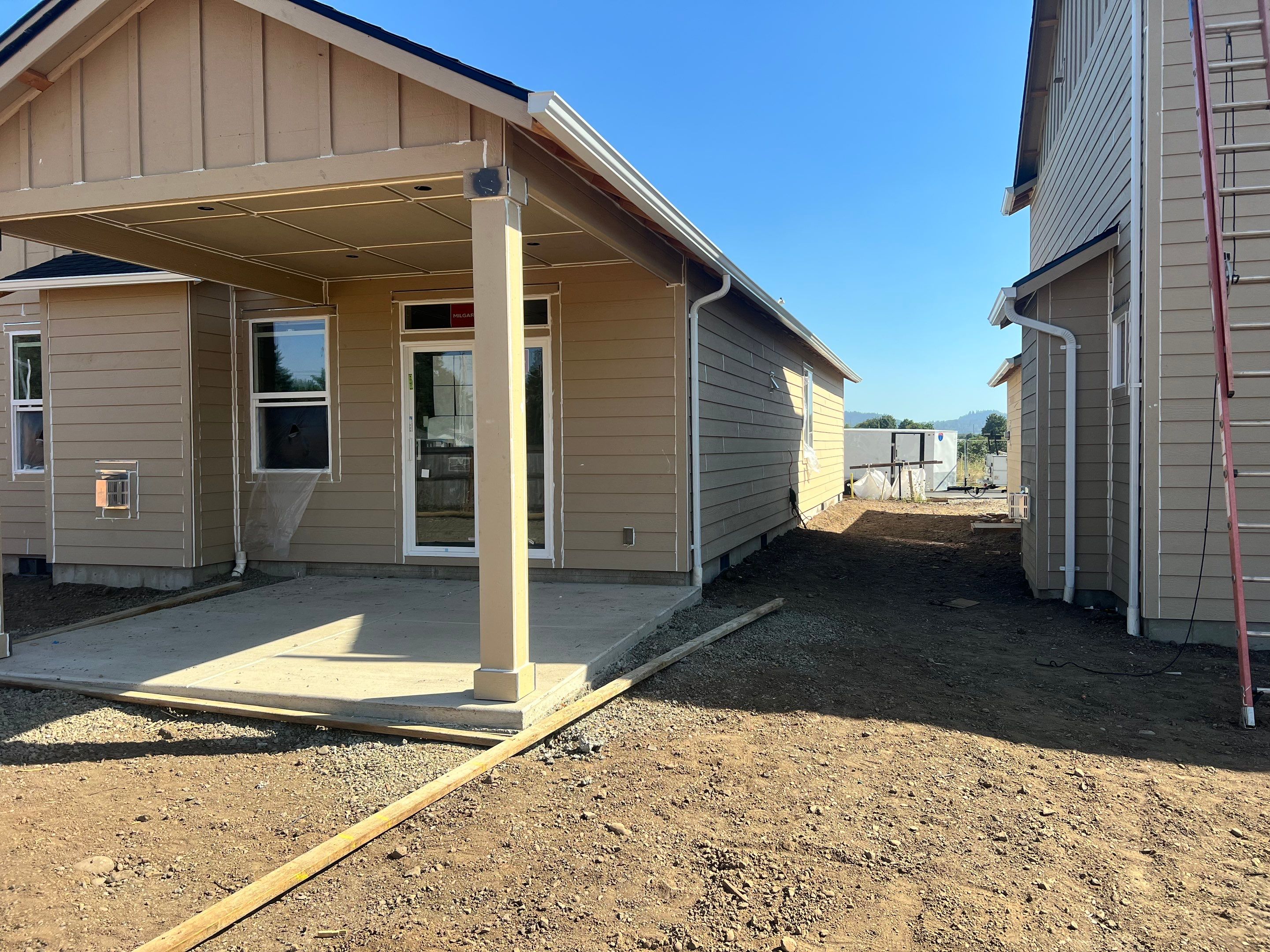 Continuous White Gutter and Downspout Installation for New Eugene Home by BEST Roofing & Waterproofing