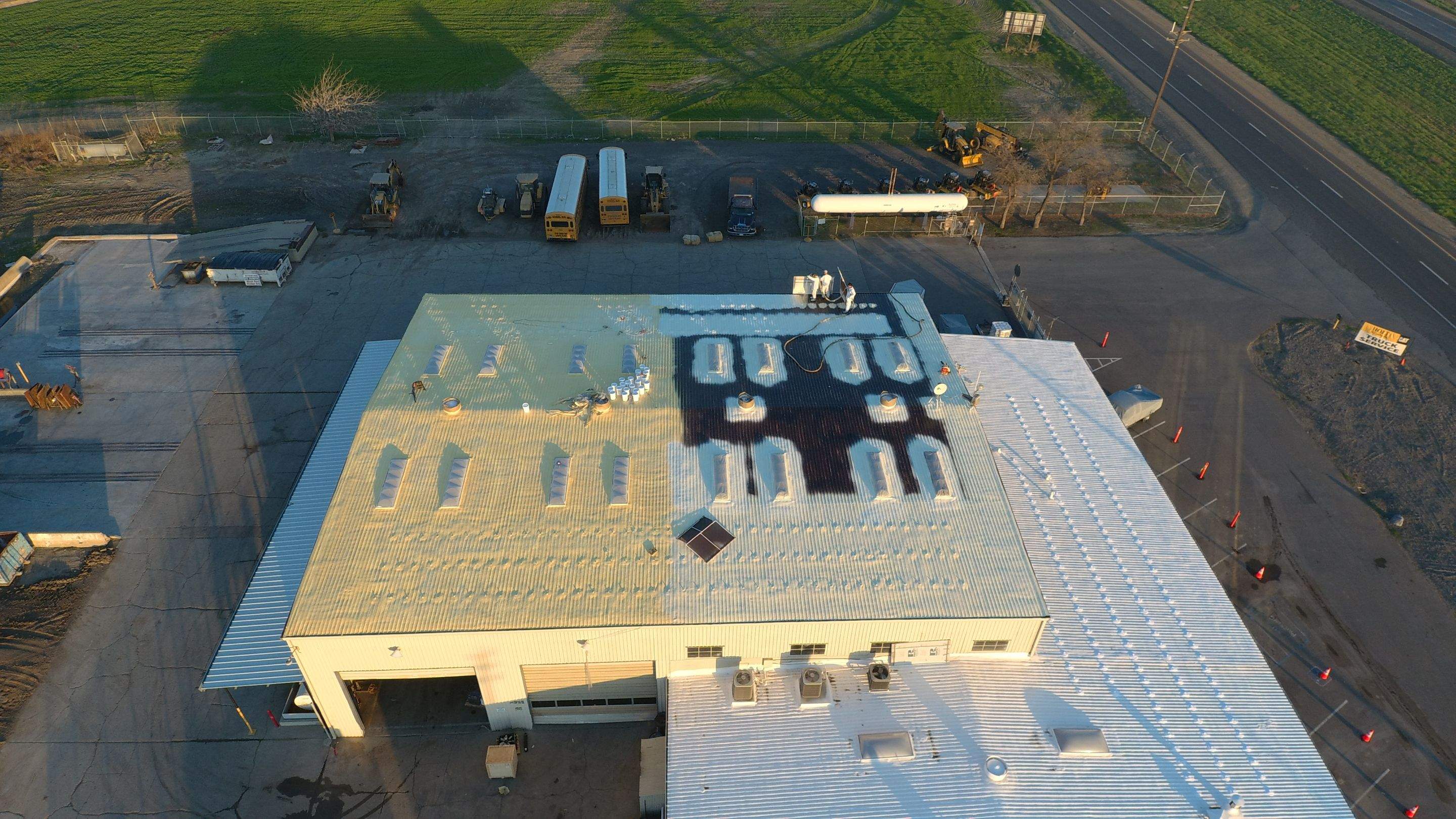 Metal roof restoration on commercial roof using Conklin Benchmark/ PUMA XL acrylic coatings over metal and foam by Straight Edge Roofing Inc