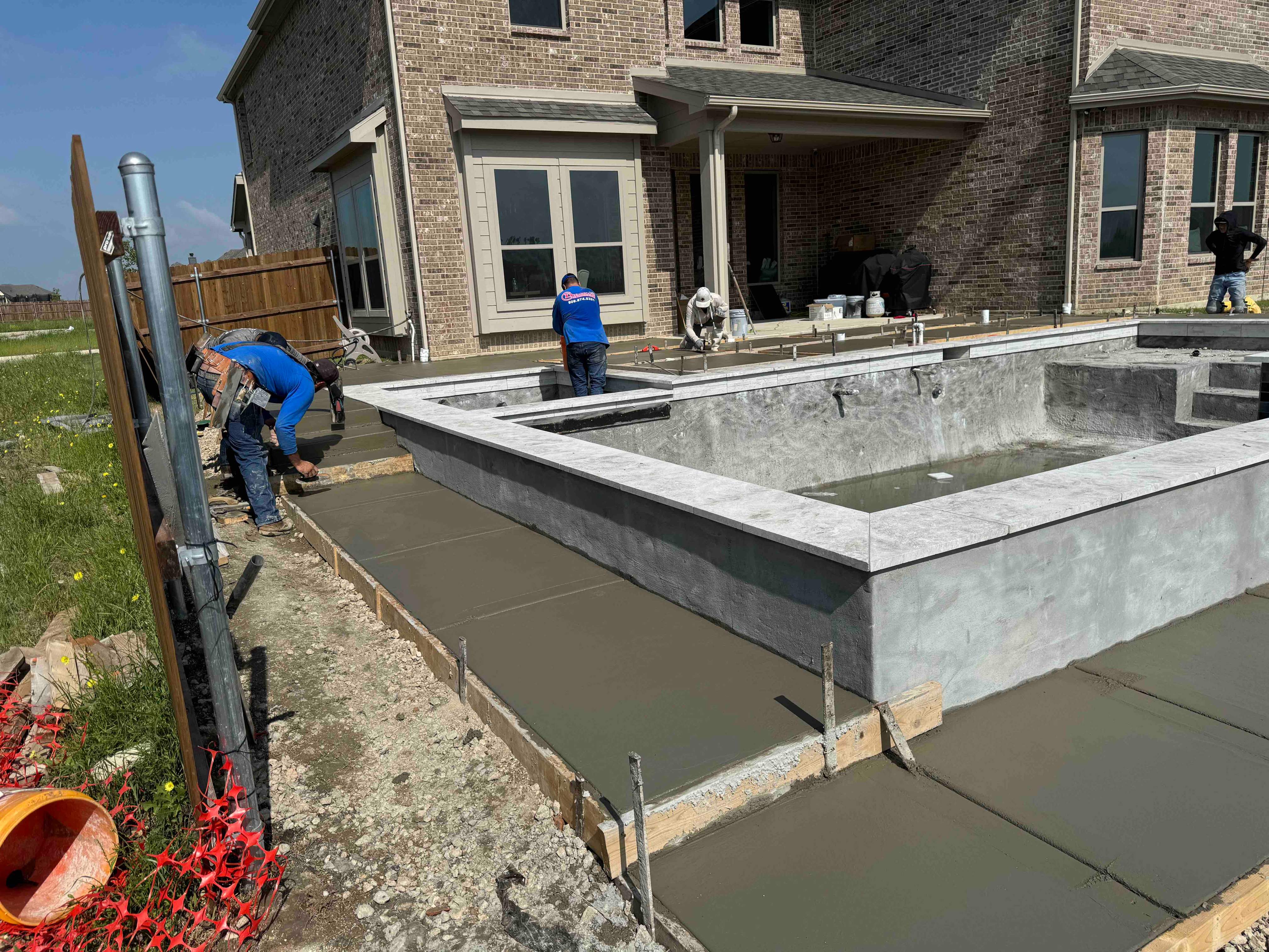 Geometric Pool with Tanning Ledge and Turf Accents by Pinnacle Pools and Spas - DFW