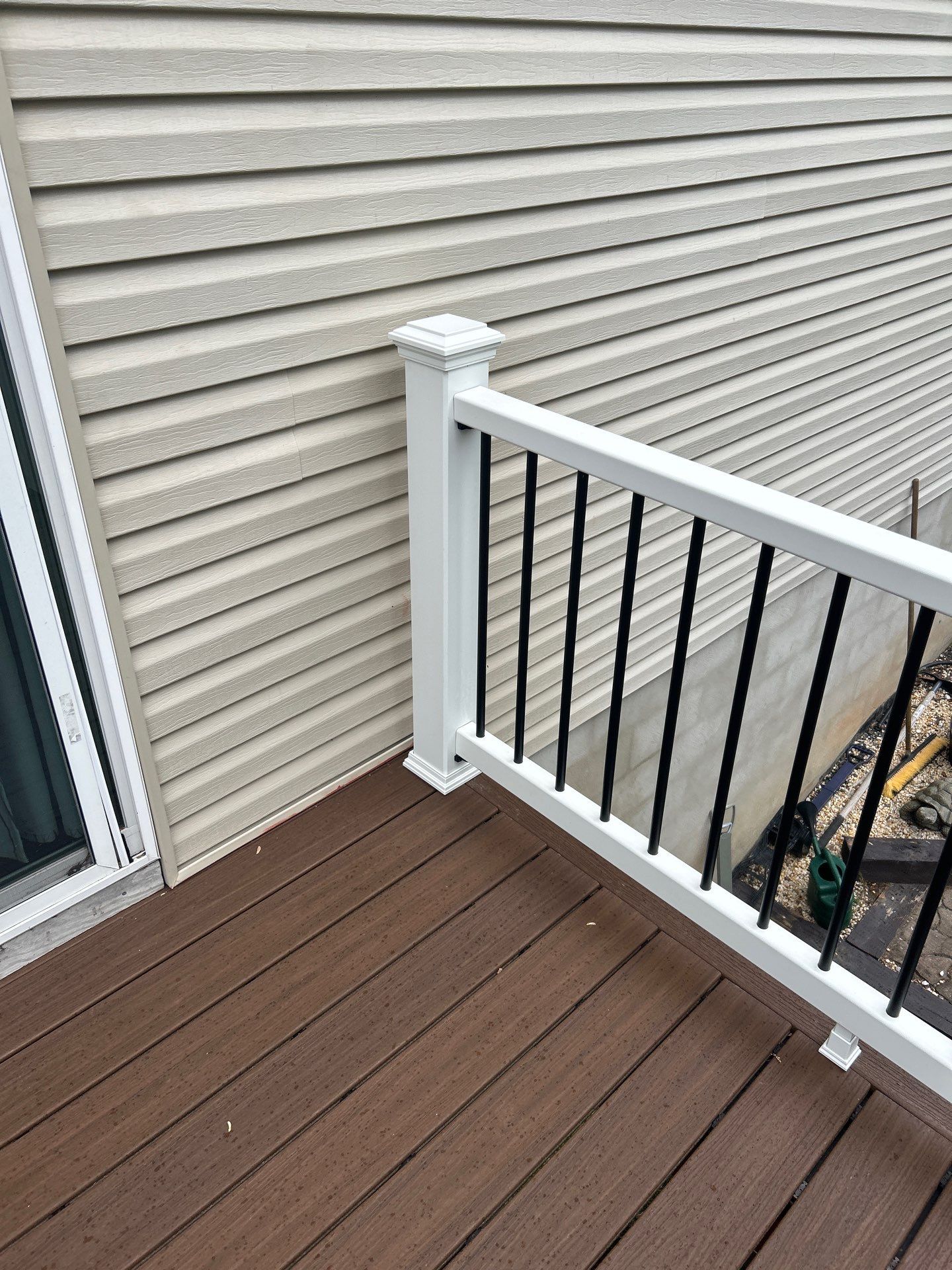 Elevated Composite Deck Replacement with White Railing in Tannersville by Herts Roofing & Construction