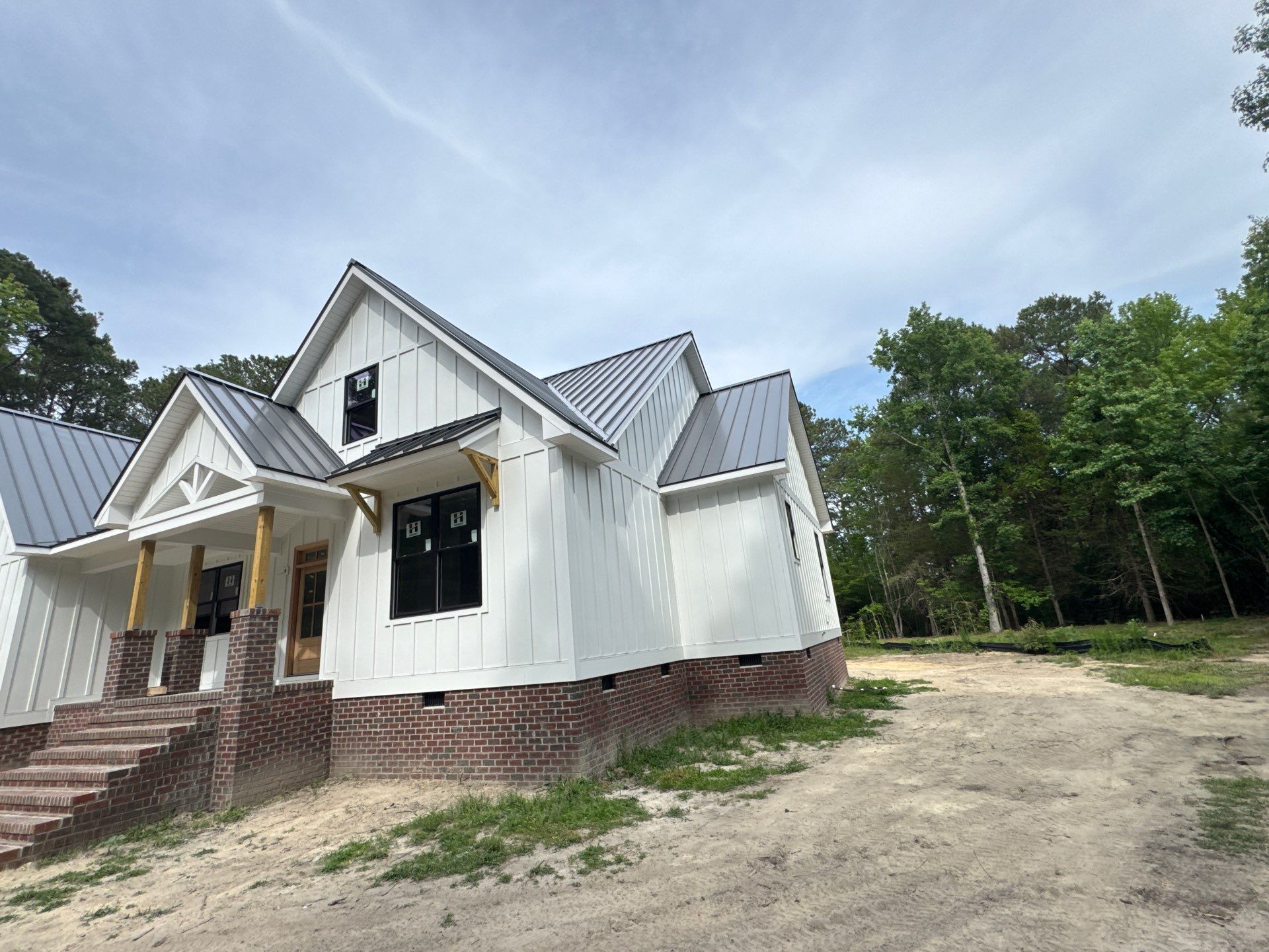 Custom New Construction Home Featuring Standing Seam Metal Roofing in Port Haywood by Cade Construction