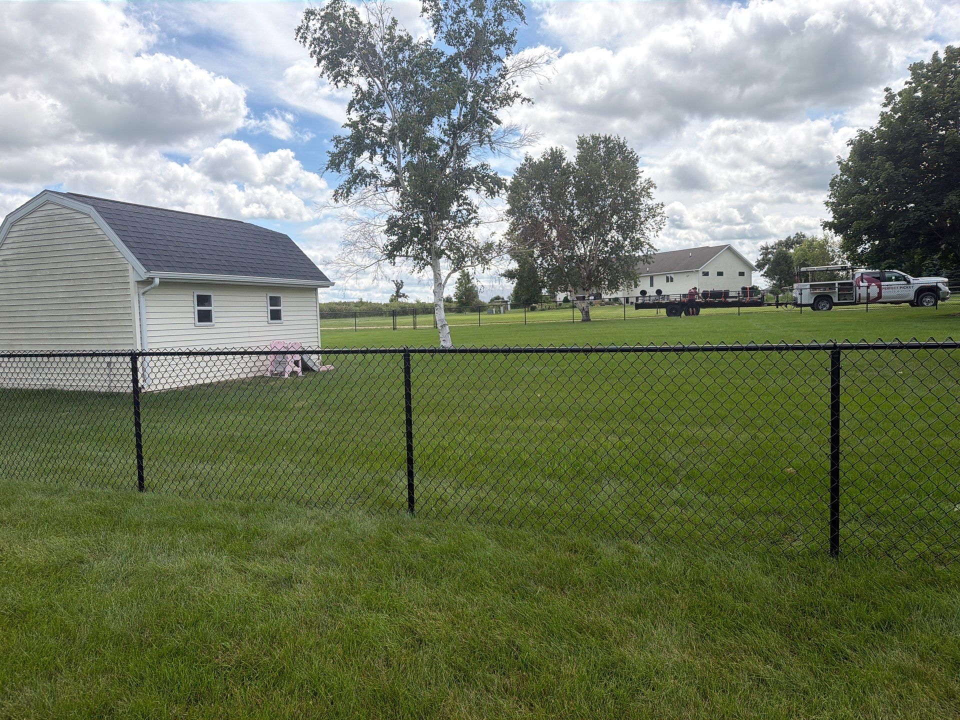 Black Vinyl-Coated Chain Link Fence Installation in Fairbank by Perfect Picket Fence and Stain