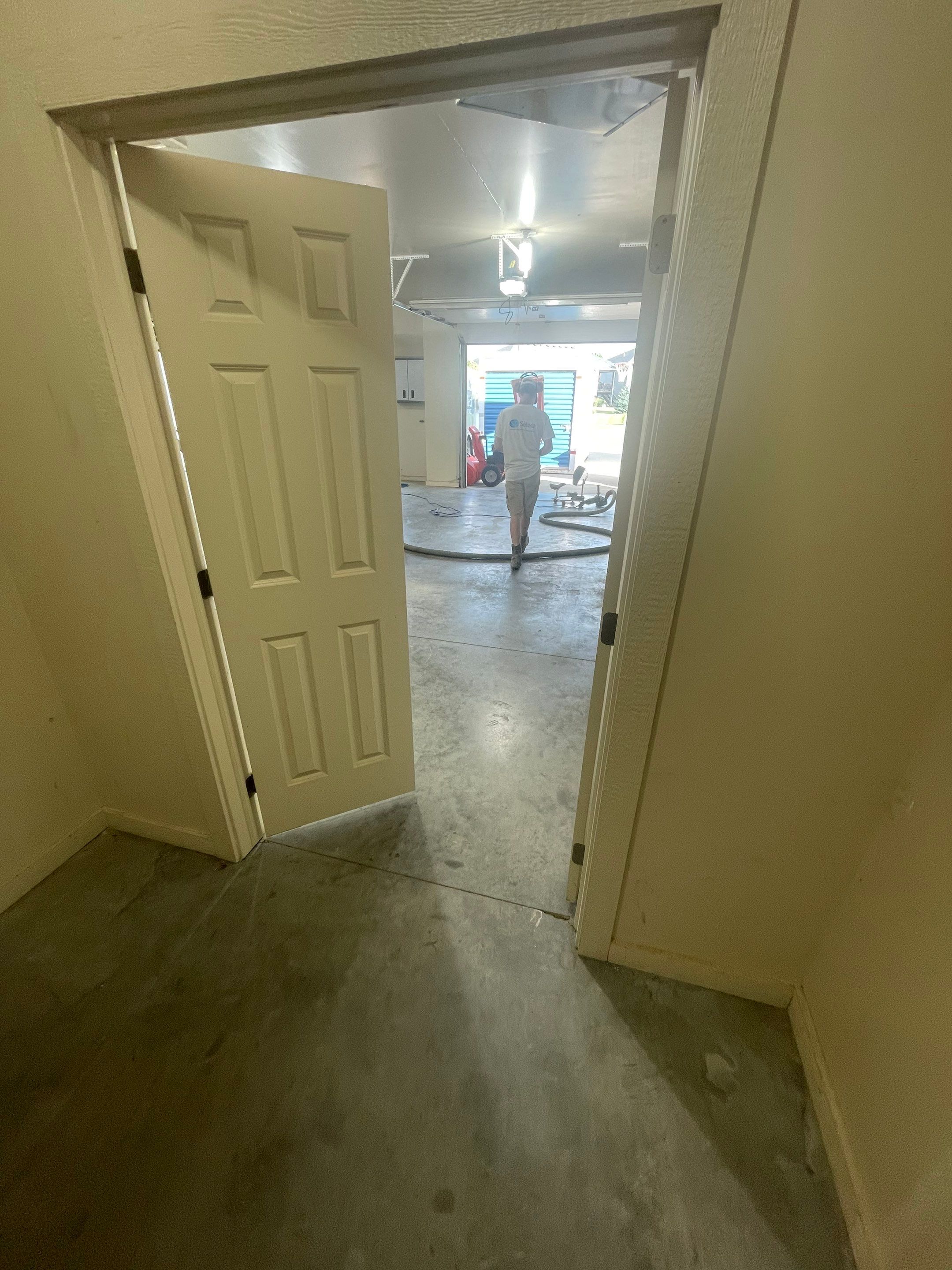 Coyote Flake Garage Floor Coating in Sioux Falls with Trench Drain by Select Painting, Coatings & Garage Cabinets