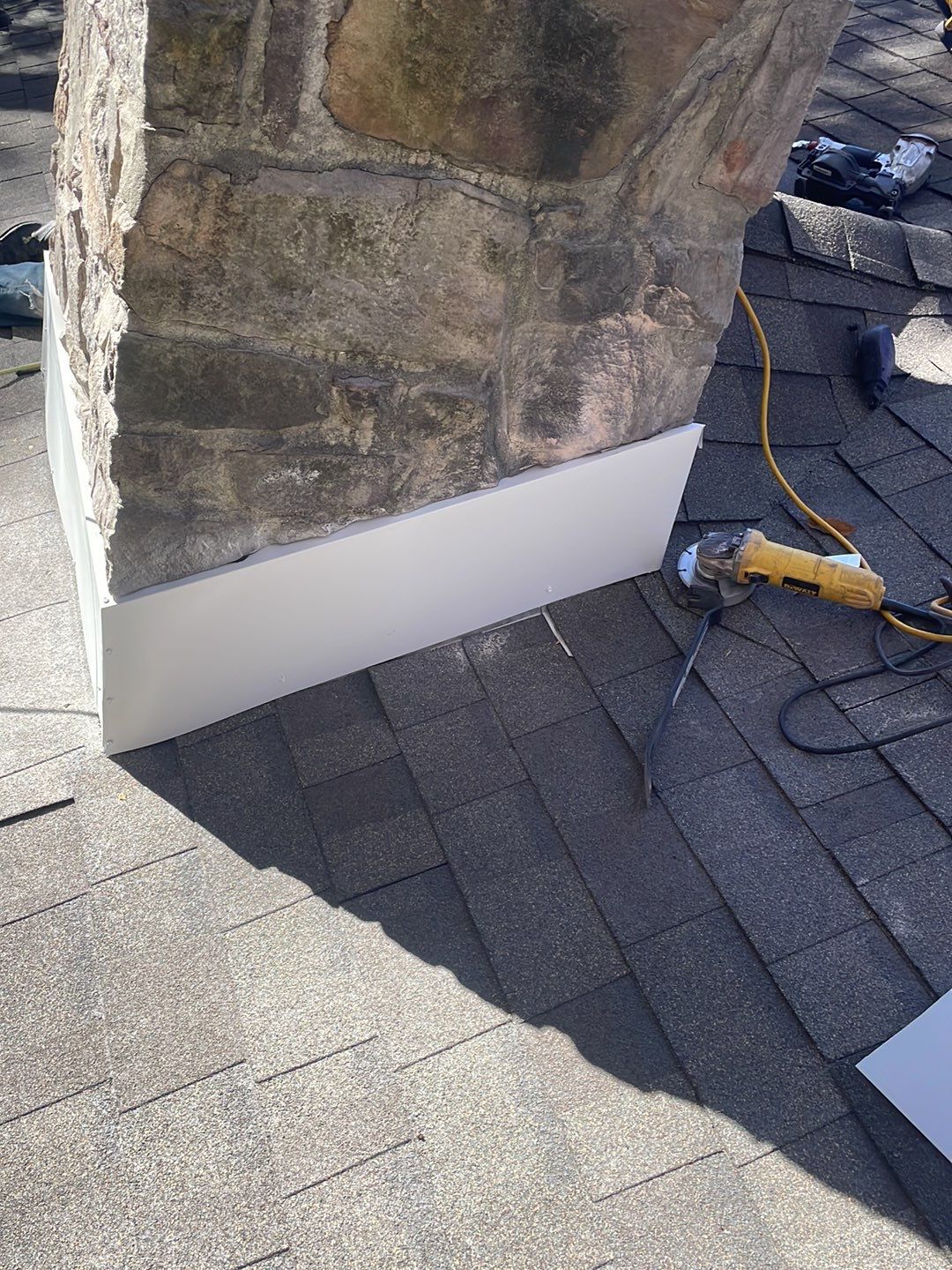 Insurance repair and chimney saddle installation. by Teflon Roofing