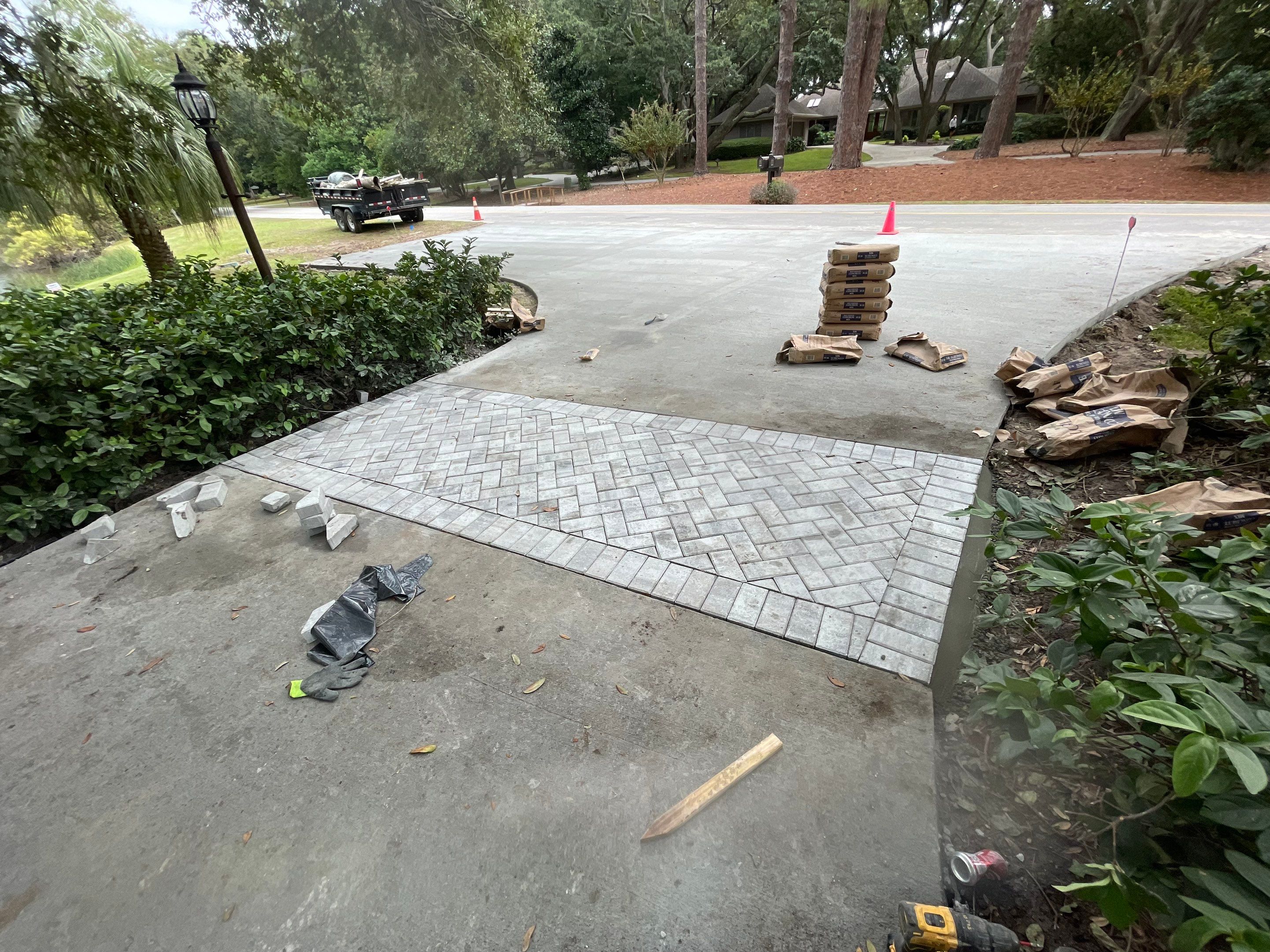 Custom Concrete Driveway with Decorative Paver Inlays in Hilton Head Island by Lowcountry Scapes, LLC