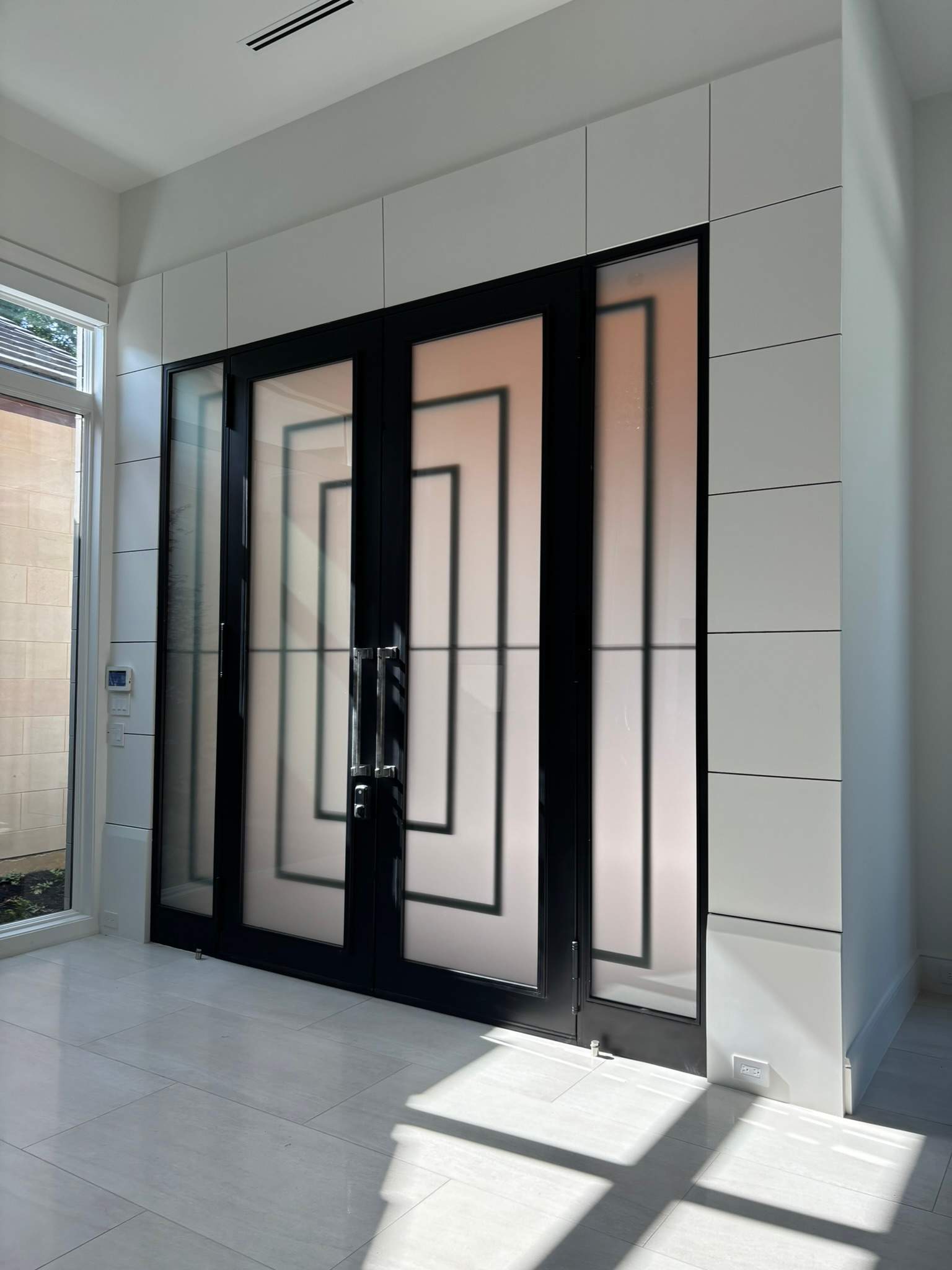 Modern Metal and Glass Entryway Installation with Custom Hardware Finishing in Dallas by Solara Custom Living
