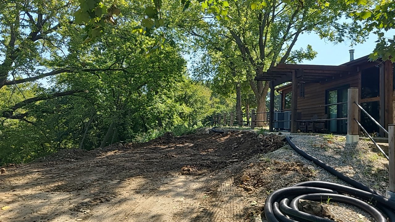 Supporting back of home with backfill at edge of steep creek by LAND ESCAPES LLC