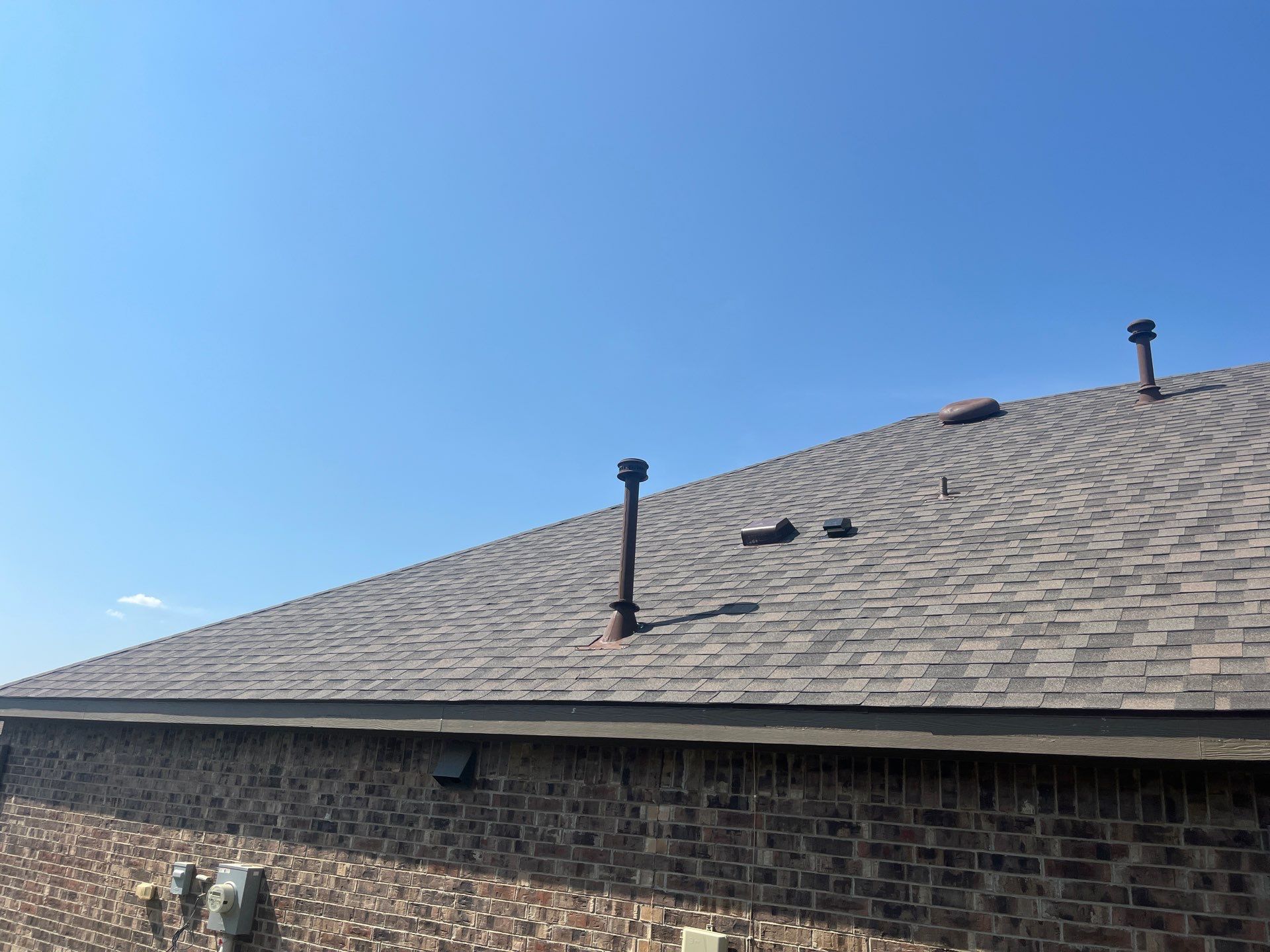 Medium brown brick with IKO Driftshake by Tejas Roofworks + Restoration