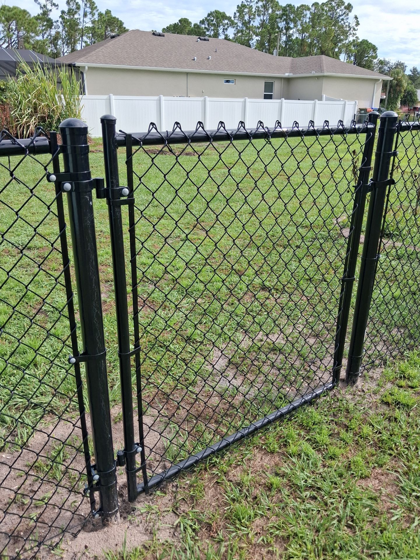 Black Chain Link Perimeter Fencing for North Port Residential Property by True Fence LLC
