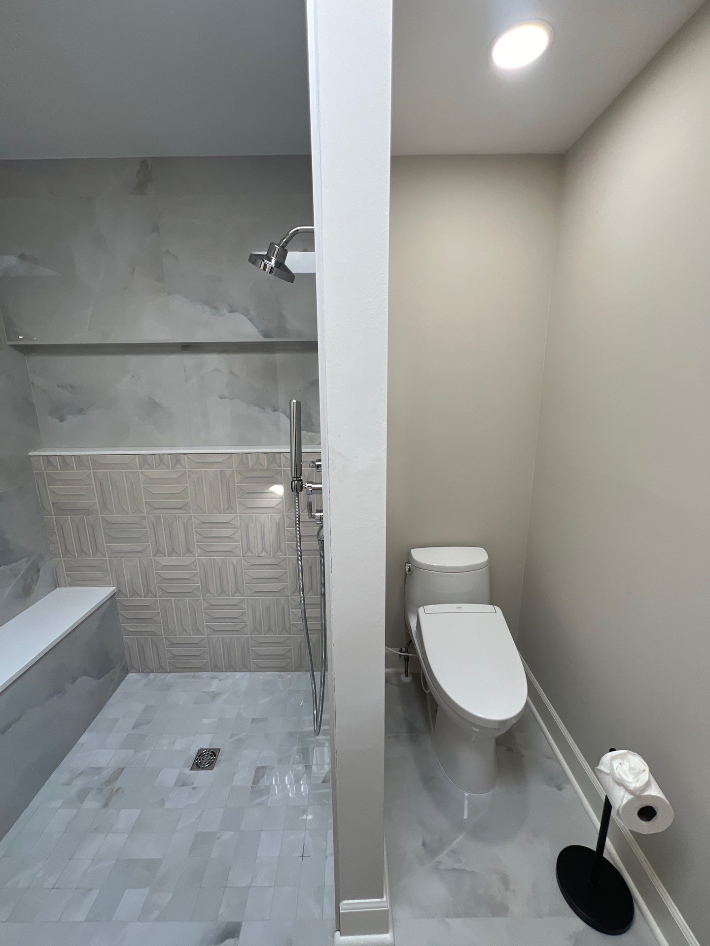 Modern Bathroom Remodeling Featuring Marble Tiles and Custom Cabinetry in Smyrna by Swift Home Renovations