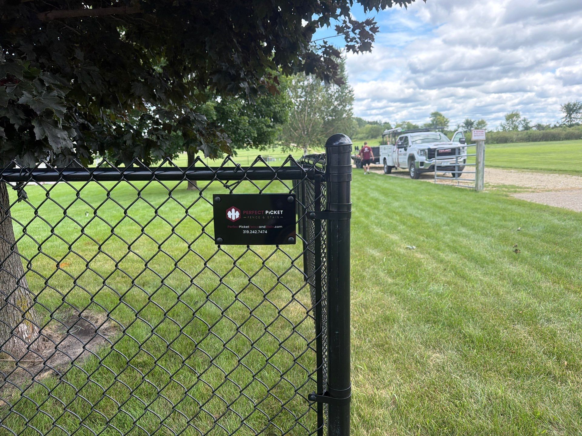 Black Vinyl-Coated Chain Link Fence Installation in Fairbank by Perfect Picket Fence and Stain
