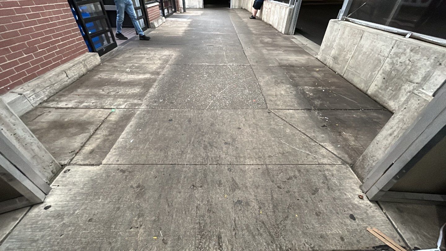 Concrete sidewalk cleaning and degreasing by Northern Power Washing LLC.