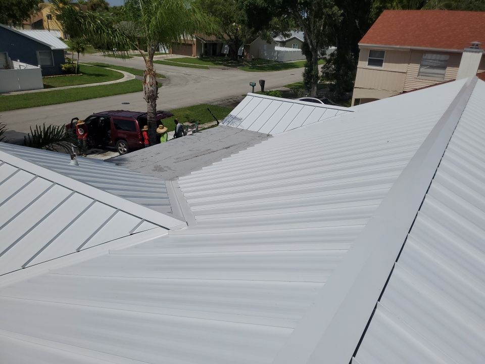 Residential Roofing Installation using 1.5" Nail Strip 24ga Solar White Kynar Coated Standing Seam Metal Panels by Morton Roofing, Inc.